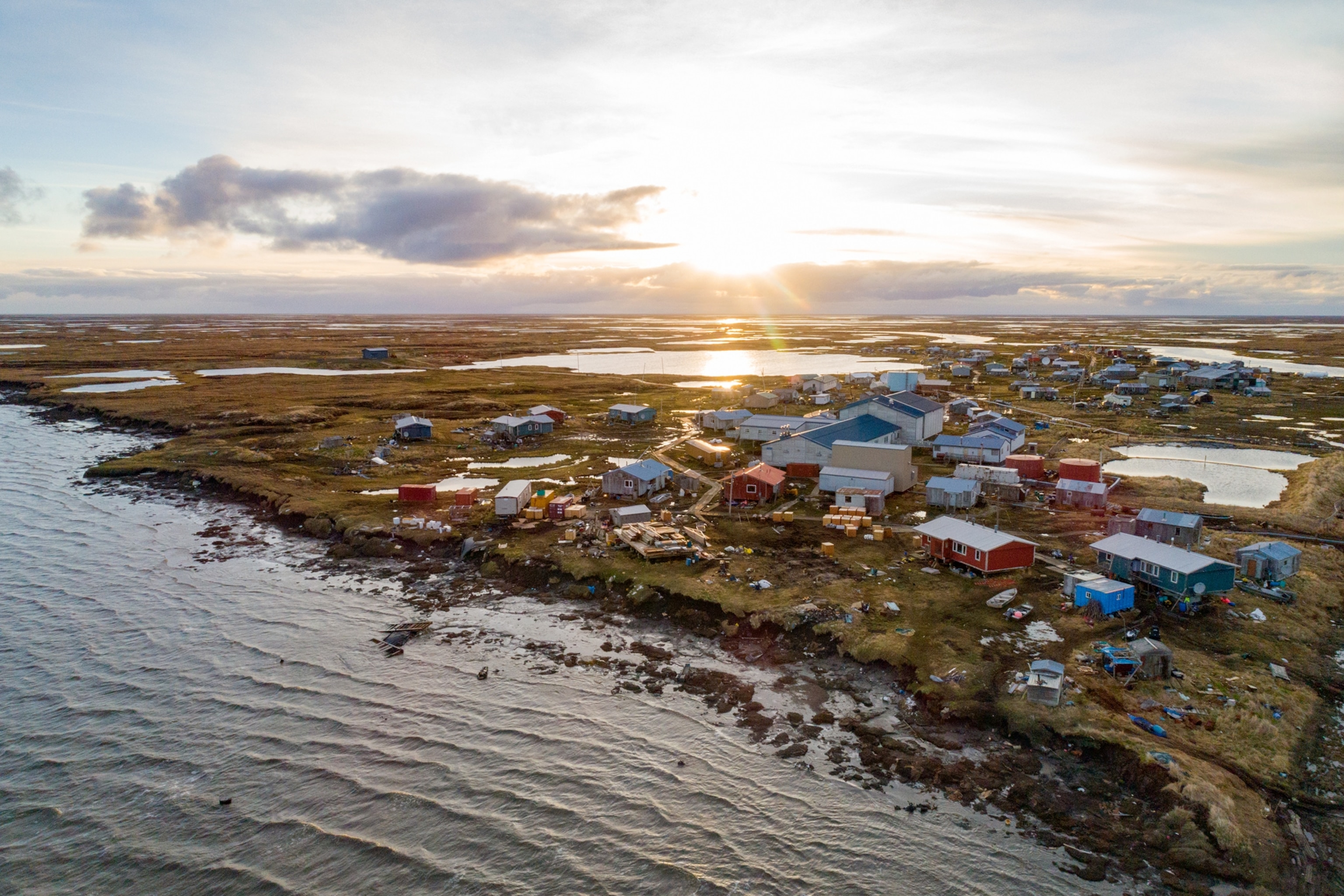 aerial view of a village on low river back.