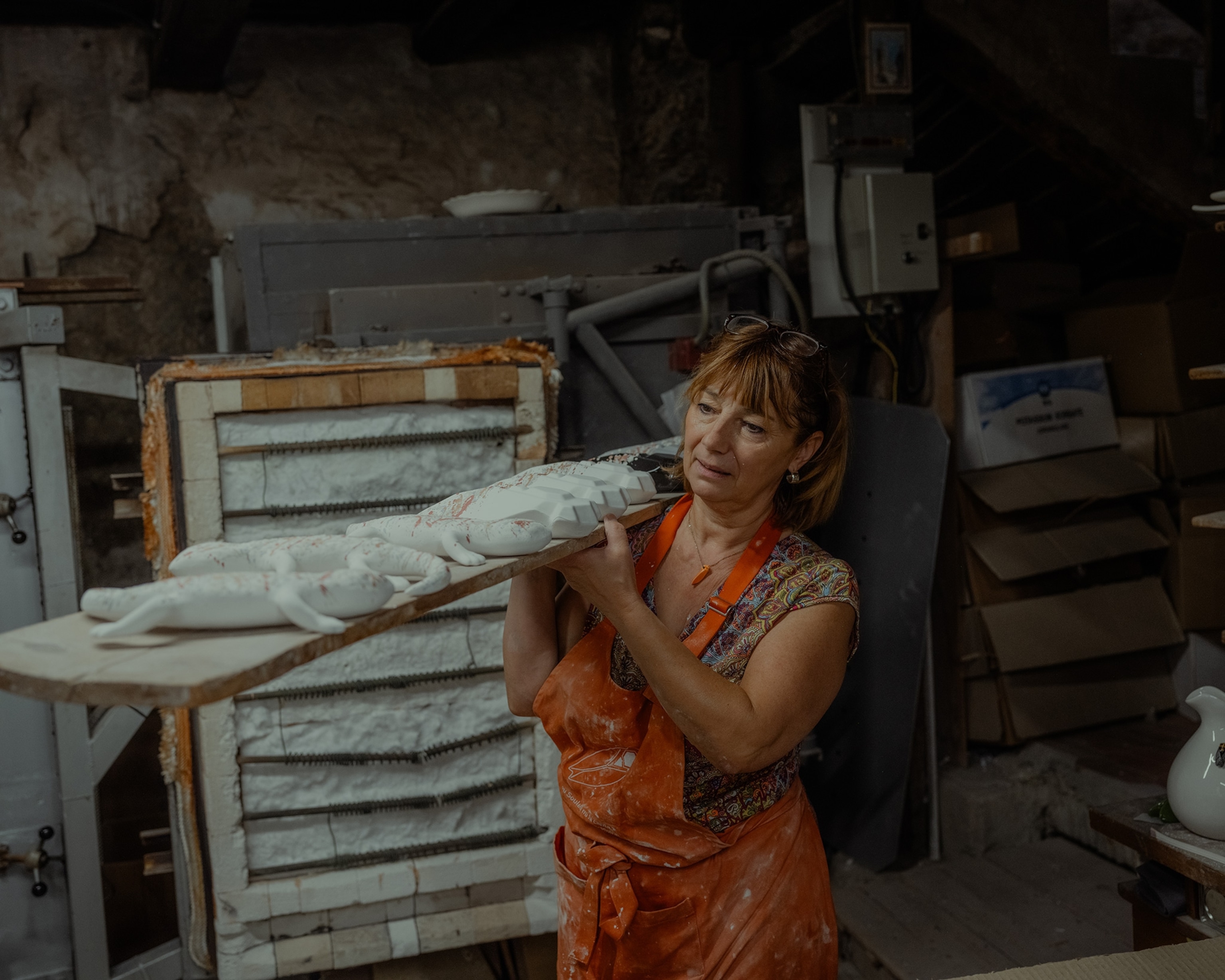 Florence Amy loads the cicadas in the kiln.