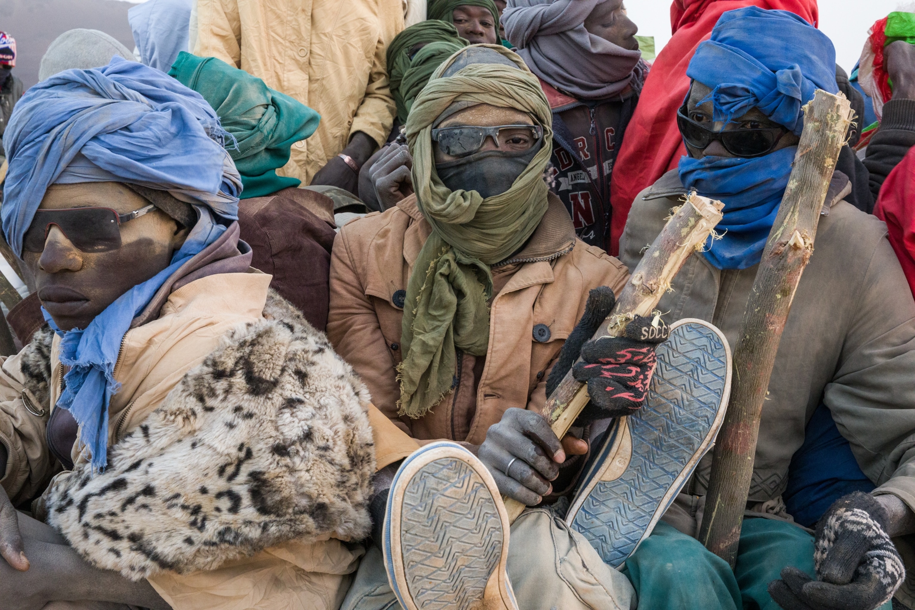 of men wearing protective clothing in the desert
