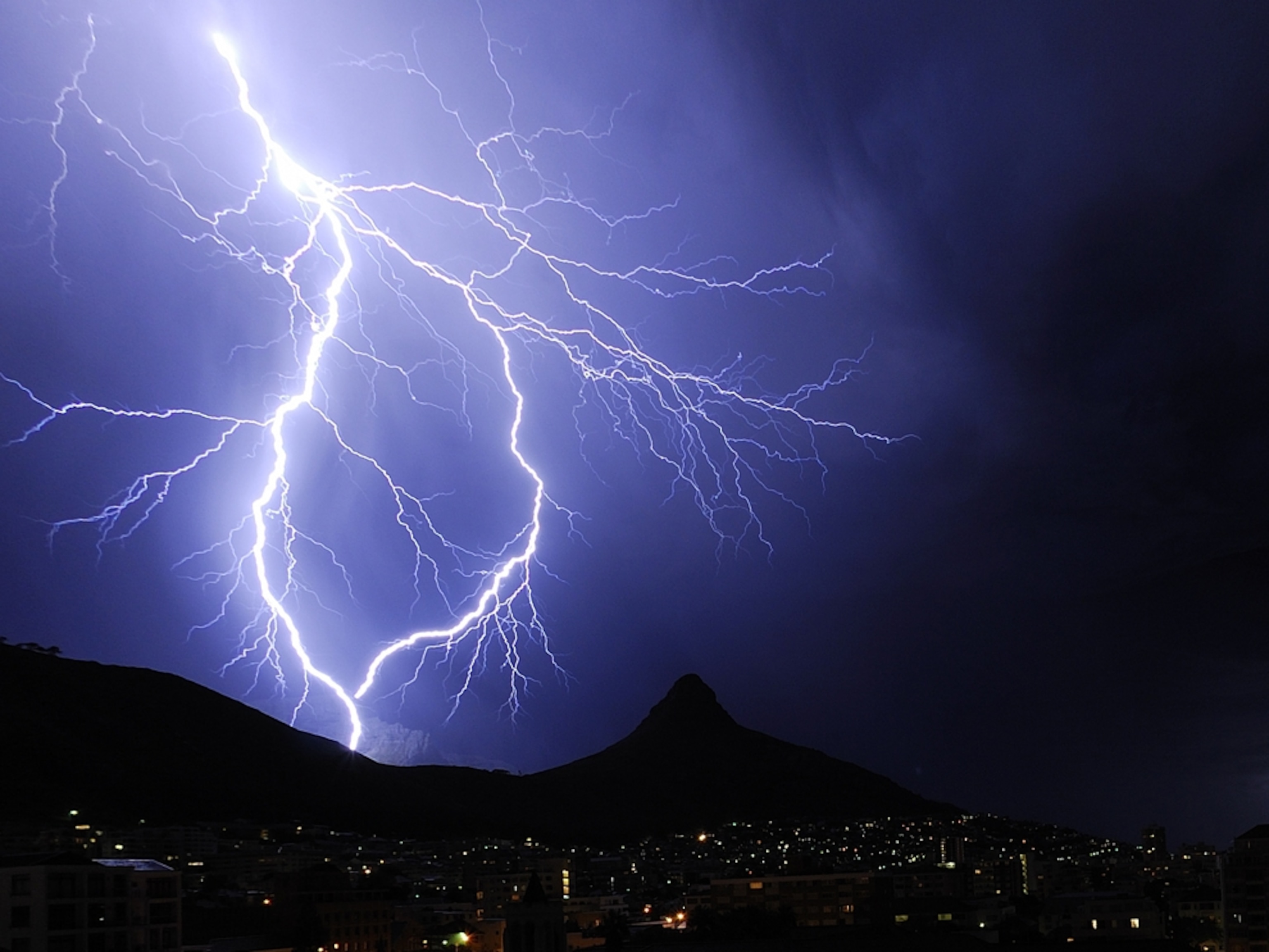 Lightning forms a circle over mountains