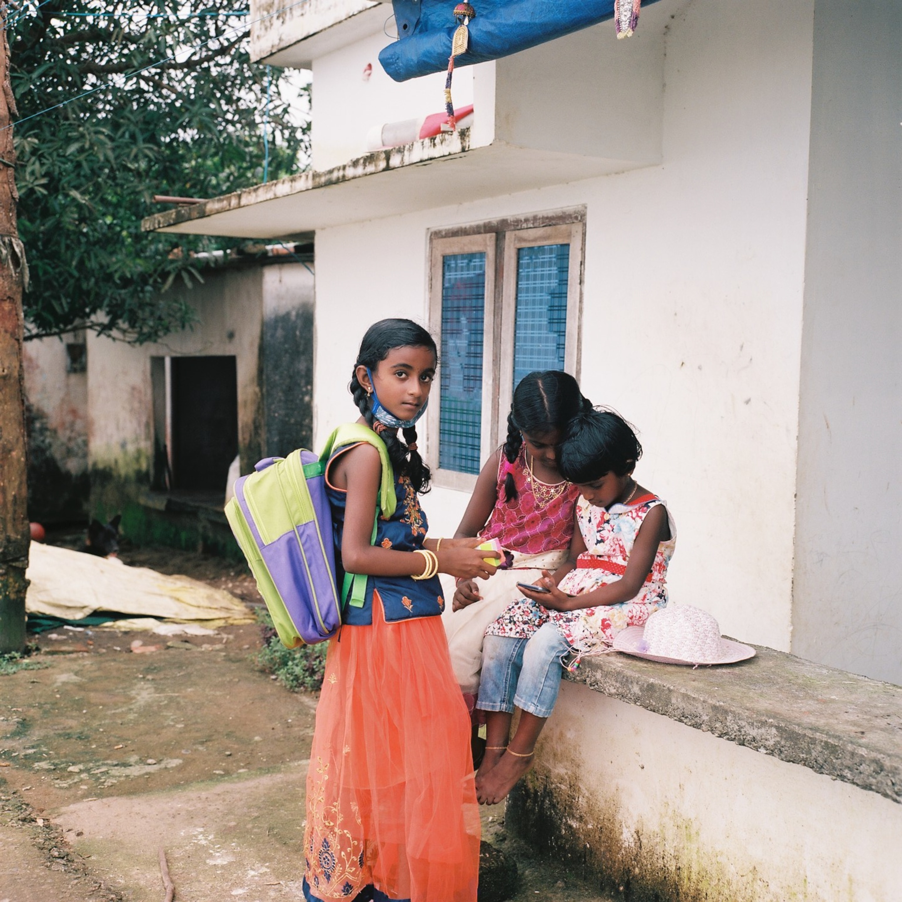 a family stands around their ancestral home