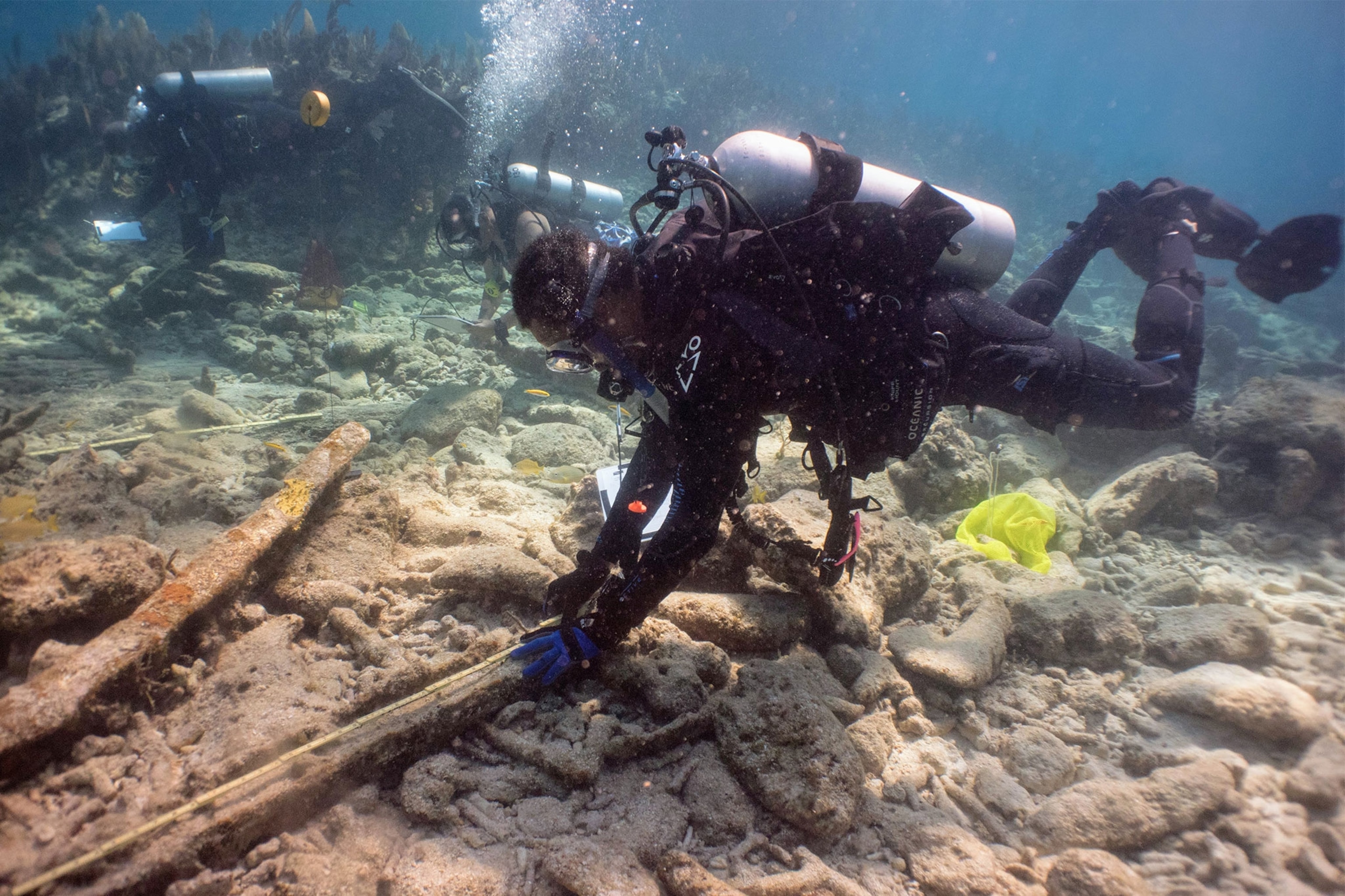 a diver examines a part of a shipwreck in the Florida Keys
