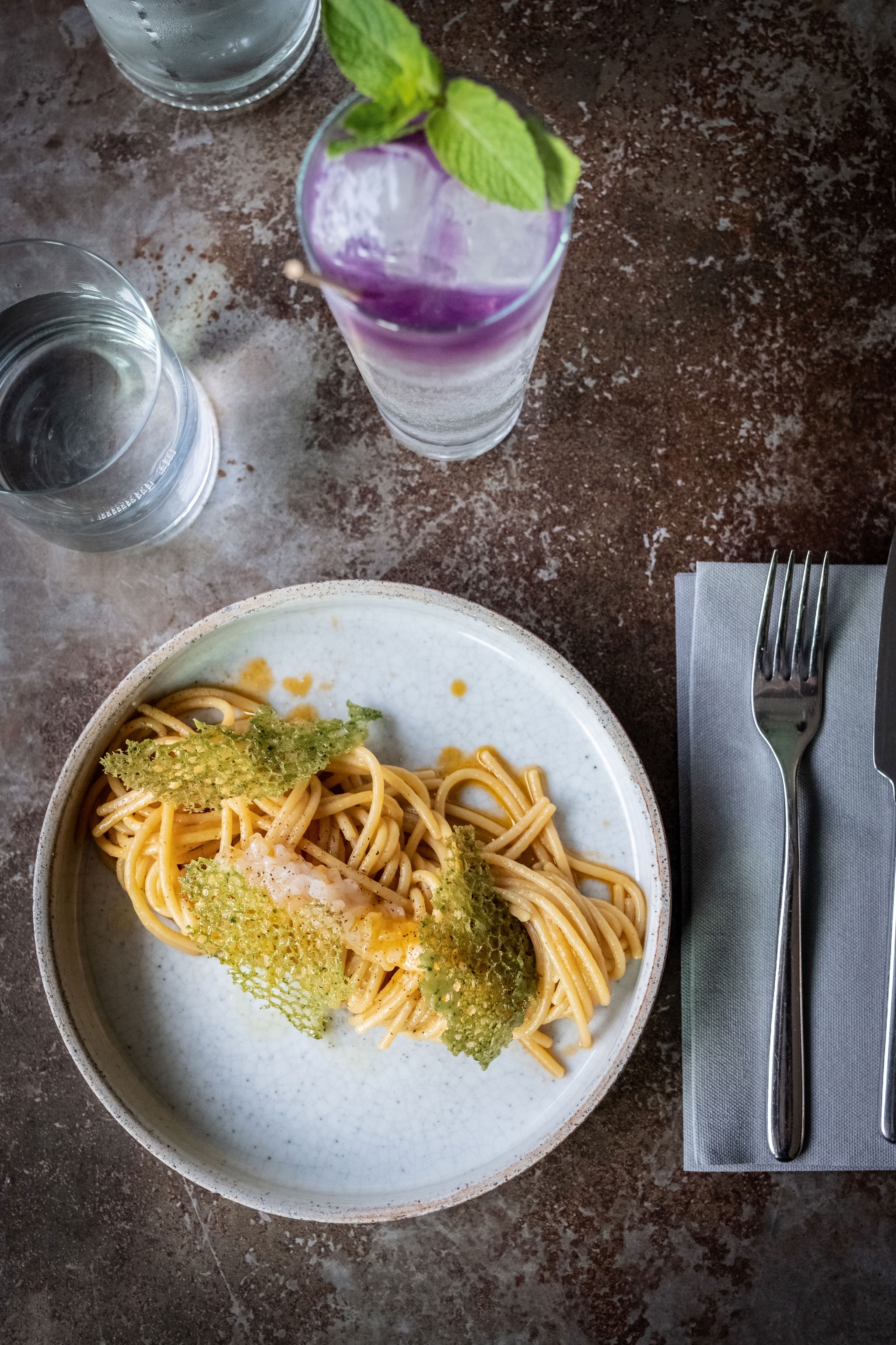 colourful spaghetti dish and cocktail from overhead
