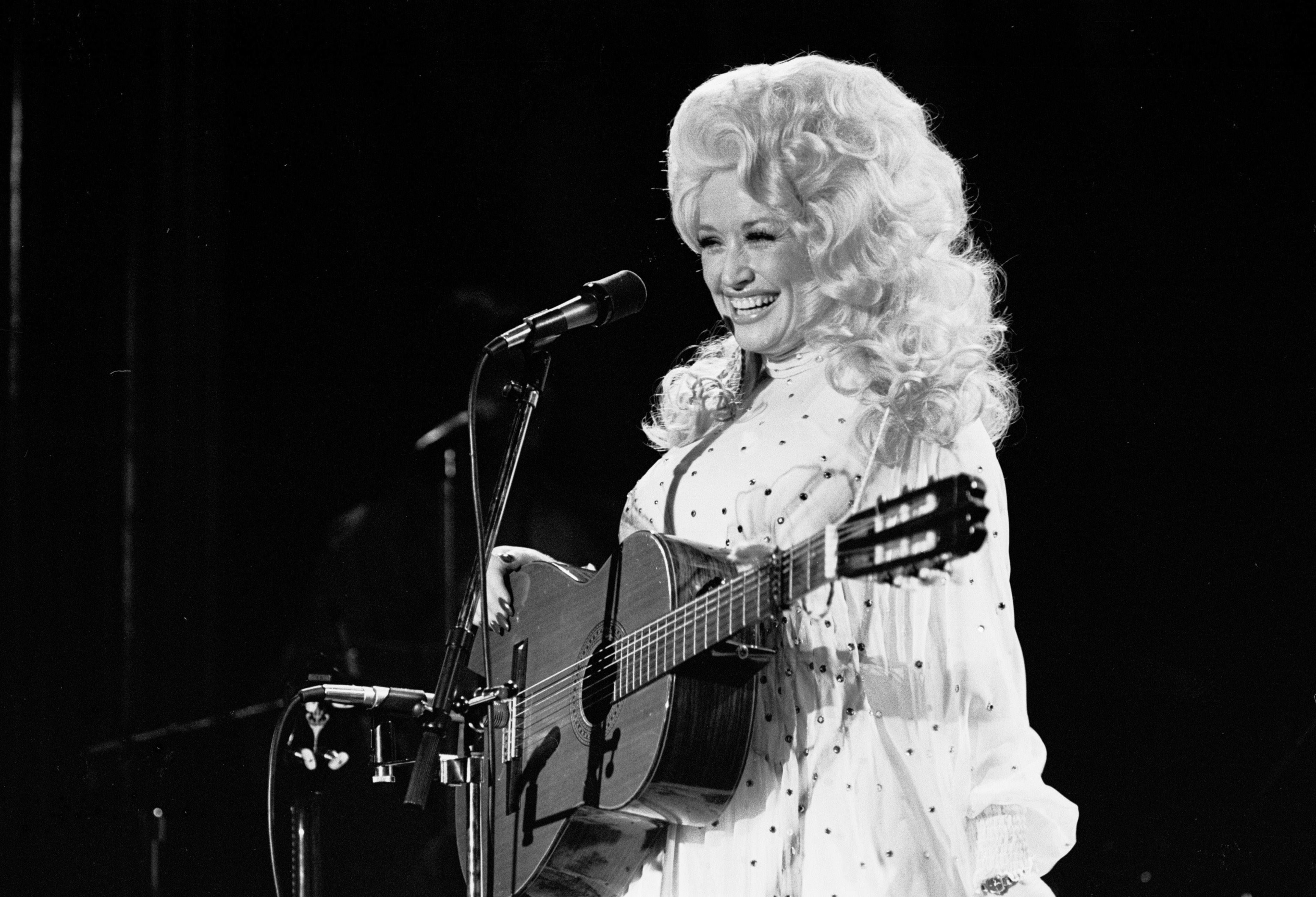 archival Photo of Dolly Parton performing onstage
