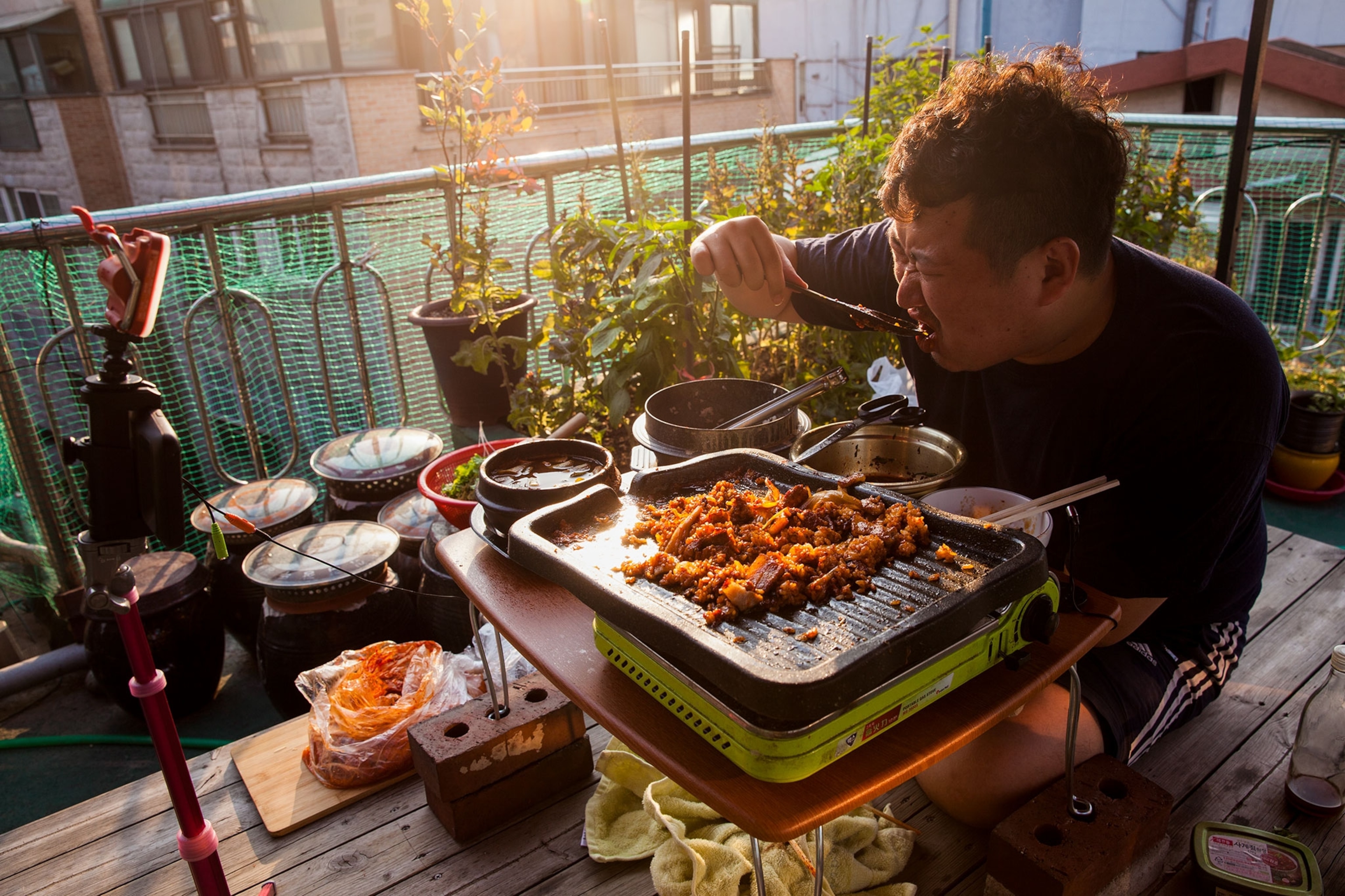 a man livestreaming while he eats in Seoul, South Korea