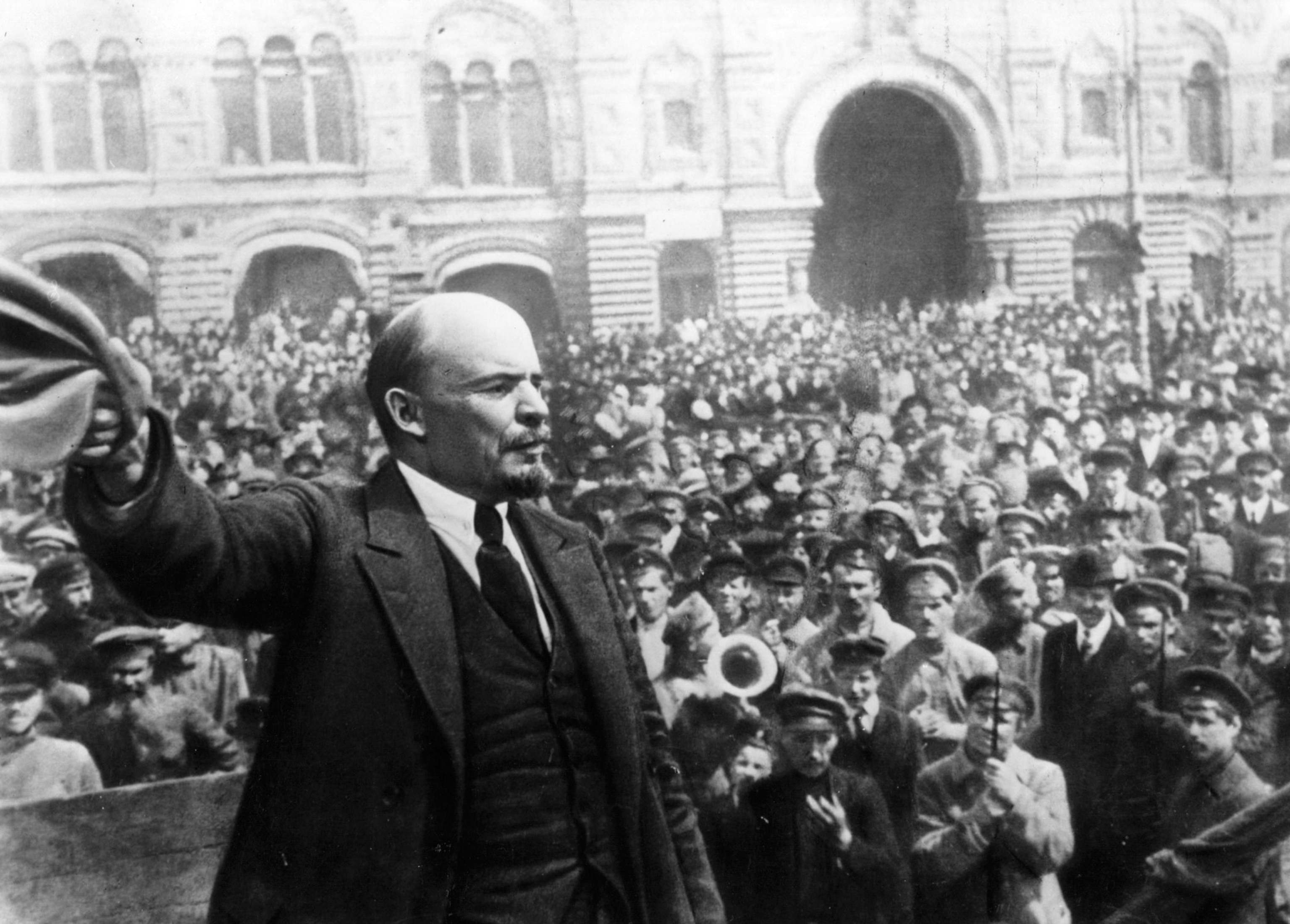 Vladimir Lenin waves his hat to a crowd