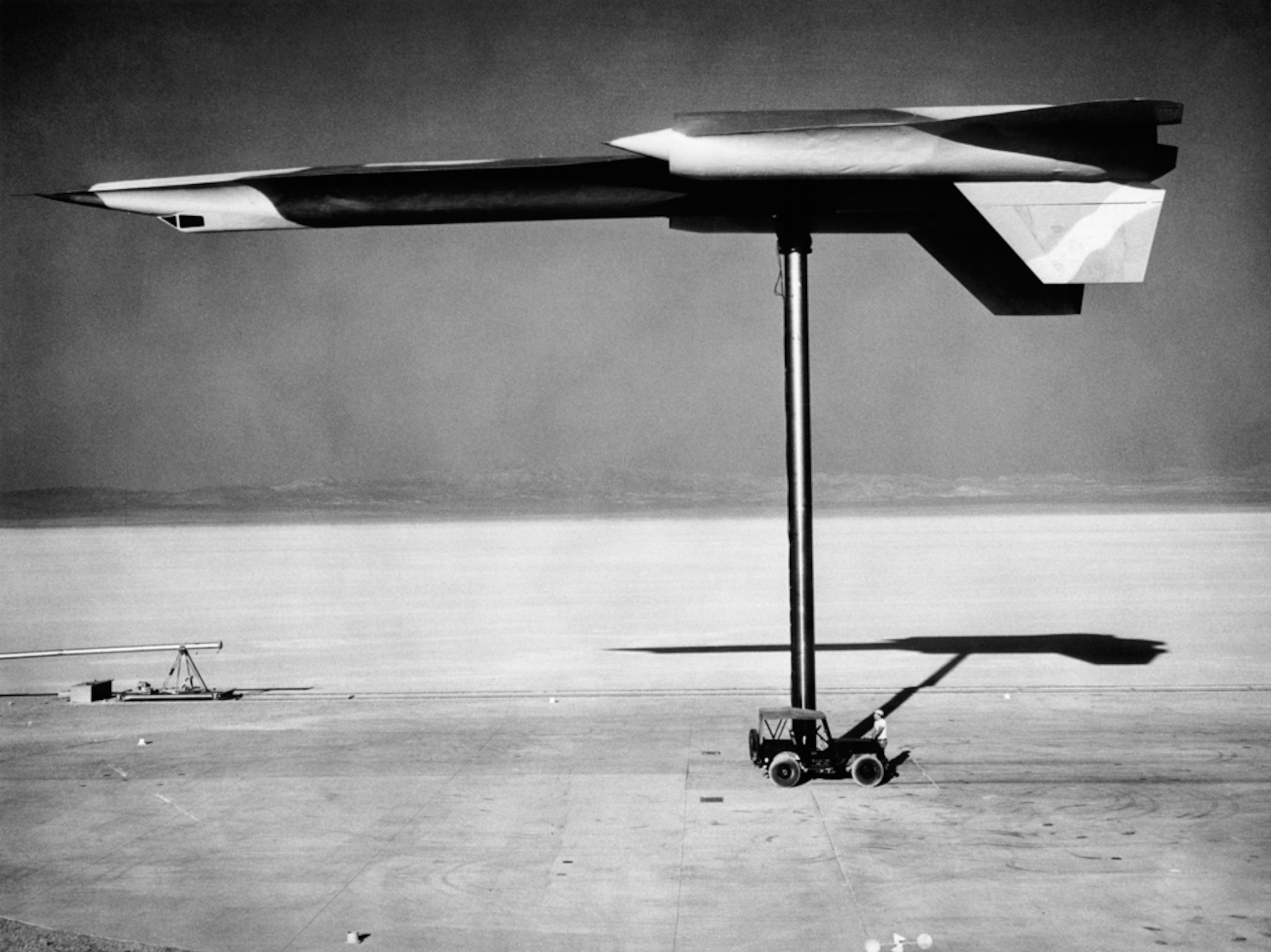 Area 51 plane crash cover-up picture: a mock-up of a secret spy plane is hoisted upside down on a pylon.
