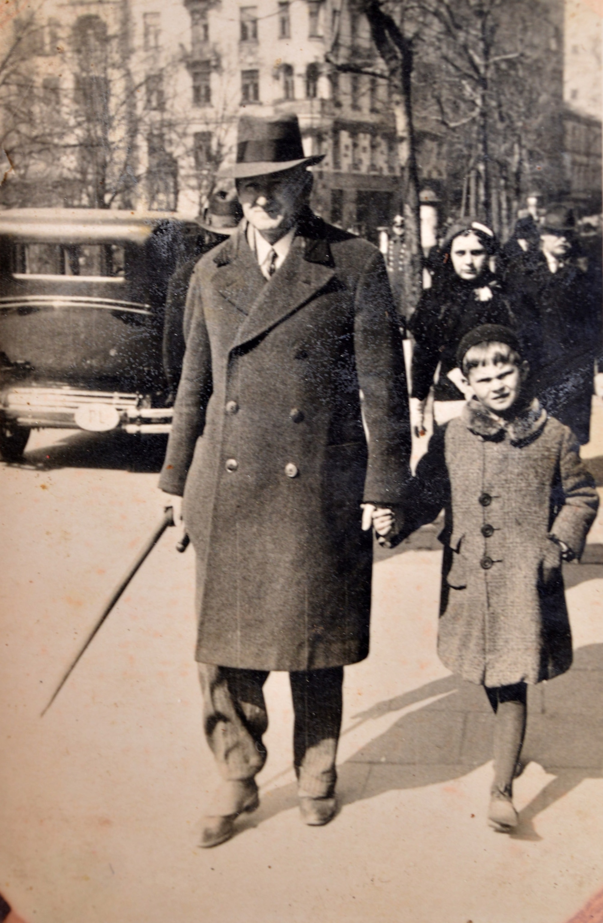 a man and his son walking in the street