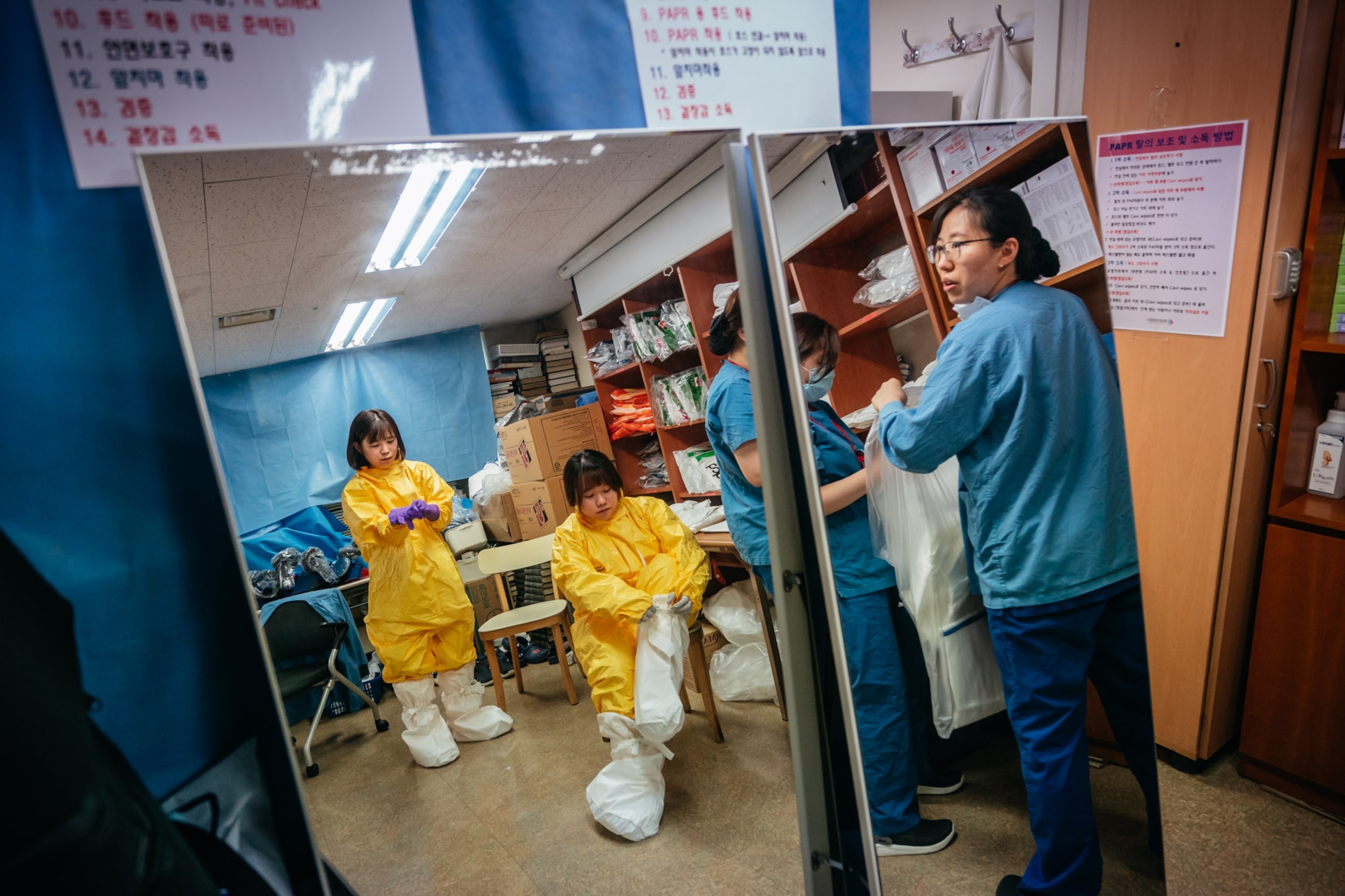 health care workers getting dressed in protective gear