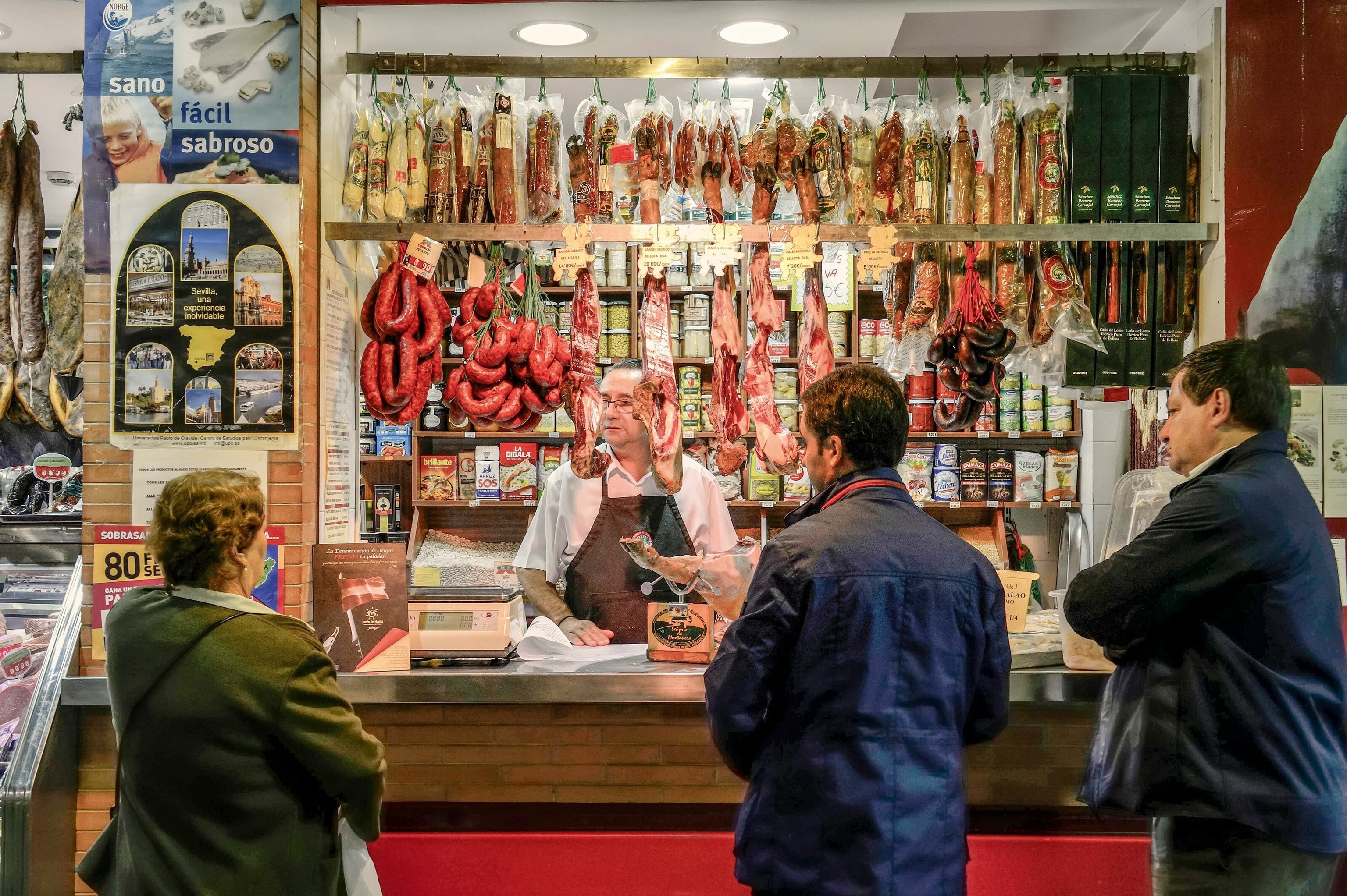 A butcher’s stall hung with legs of jamón at Mercado de Triana.