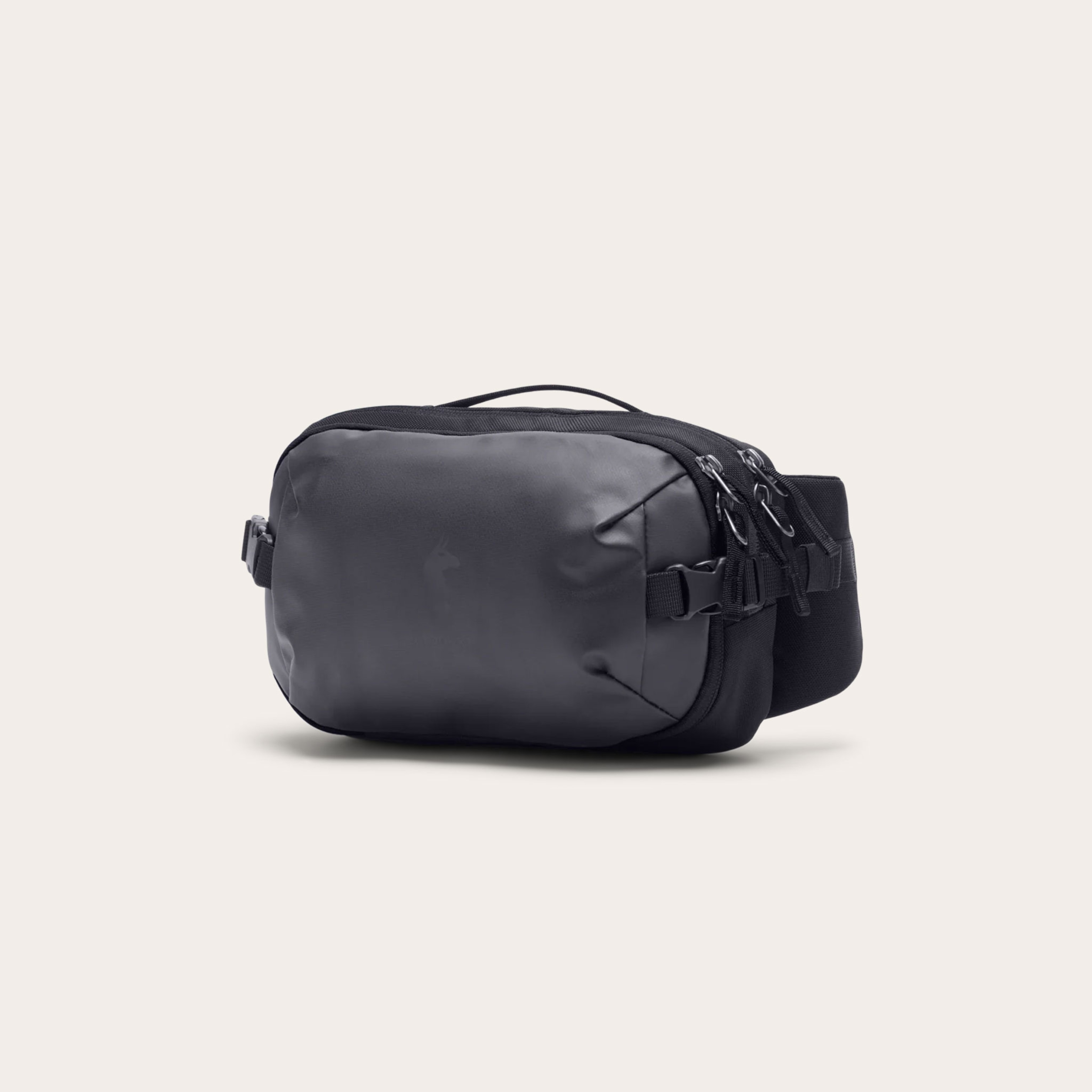 Black fanny pack placed on a tan background.