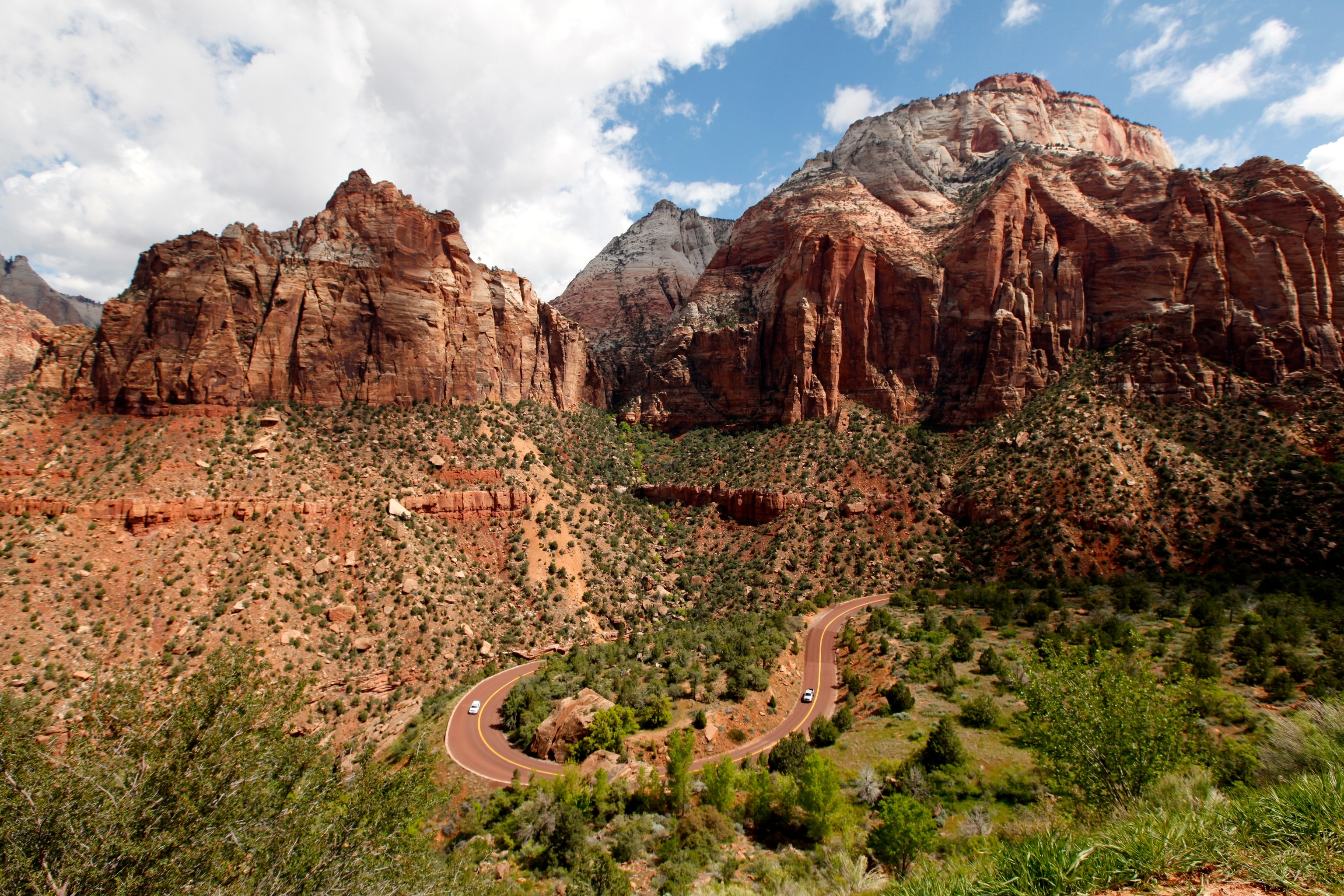 View of the red rock formations and a winding road in Zion National Park in Utah, USA.
