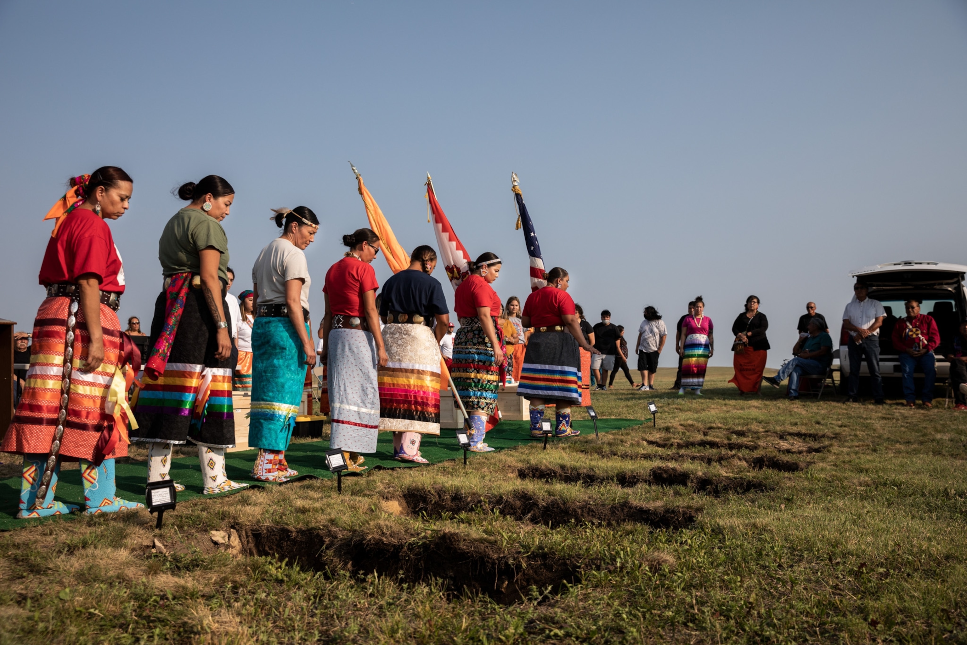 Native American people hold a ceremony to honor the remains of Indigenous children after they were discovered at a former boarding school