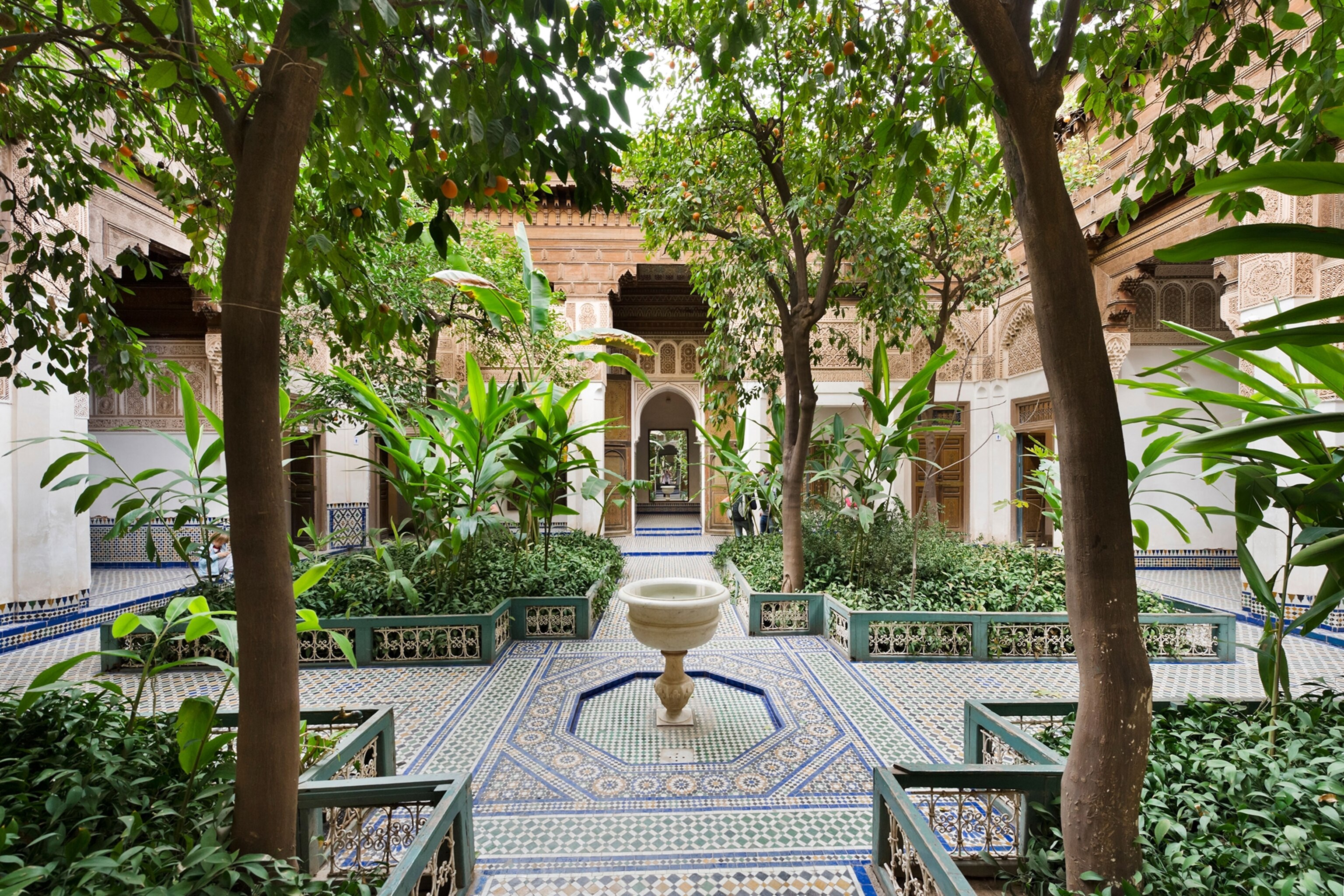 A traditional courtyard in a palace in Marrkech with a tiered water feature in the centre