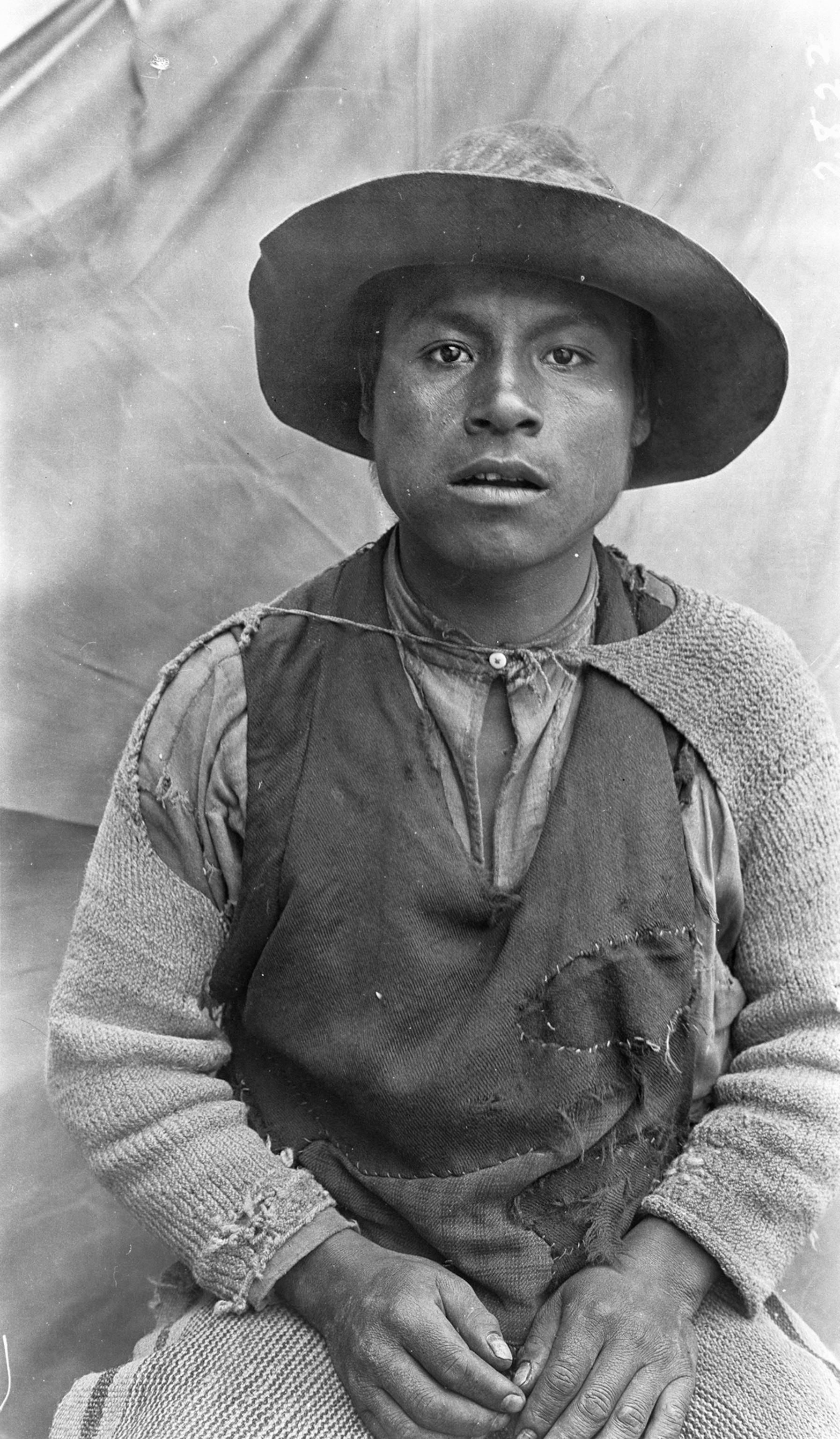 Picture of young man in all mended clothes