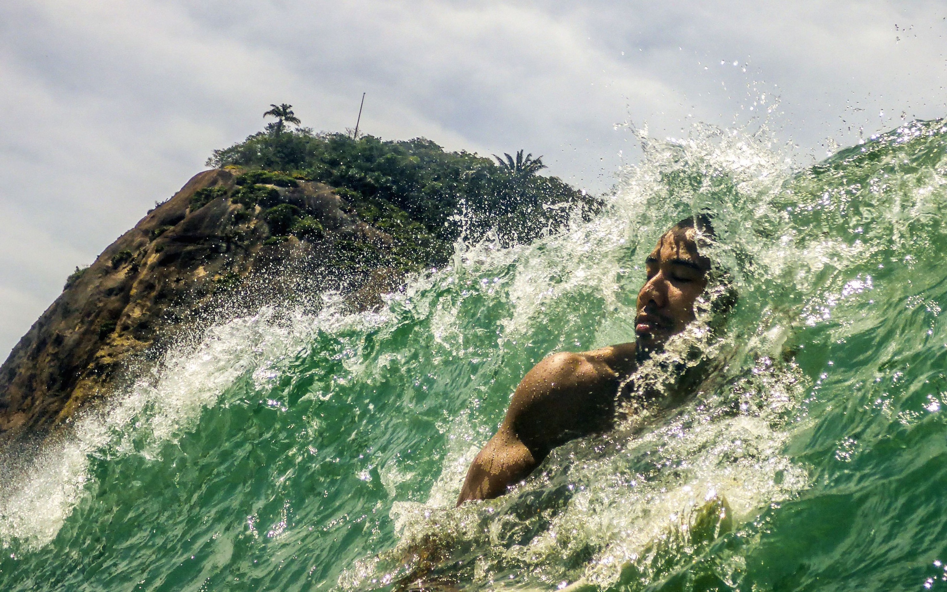 surfer in wave off Copacabana beach in Rio de Janeiro, Brazil