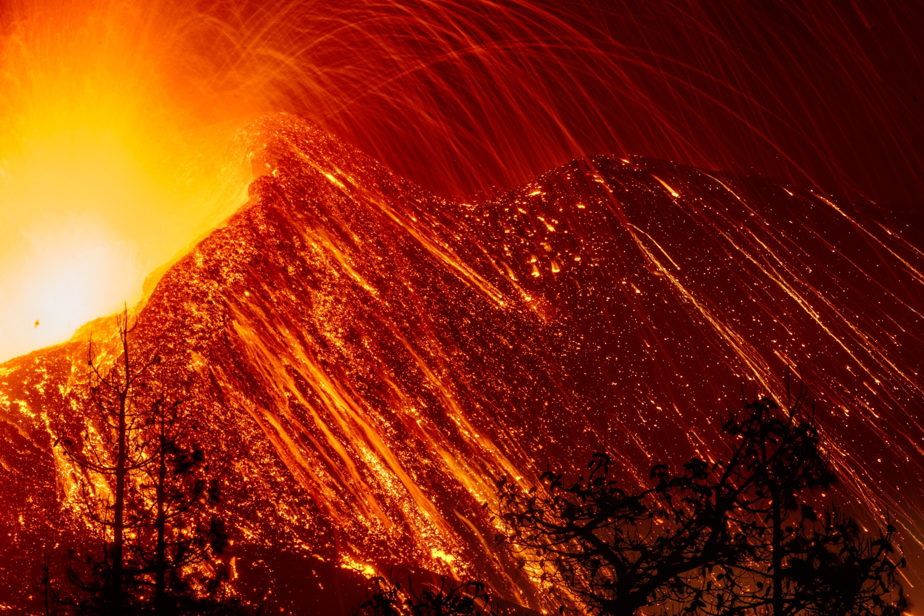 Lava explosion over a mountainous volcano ridge