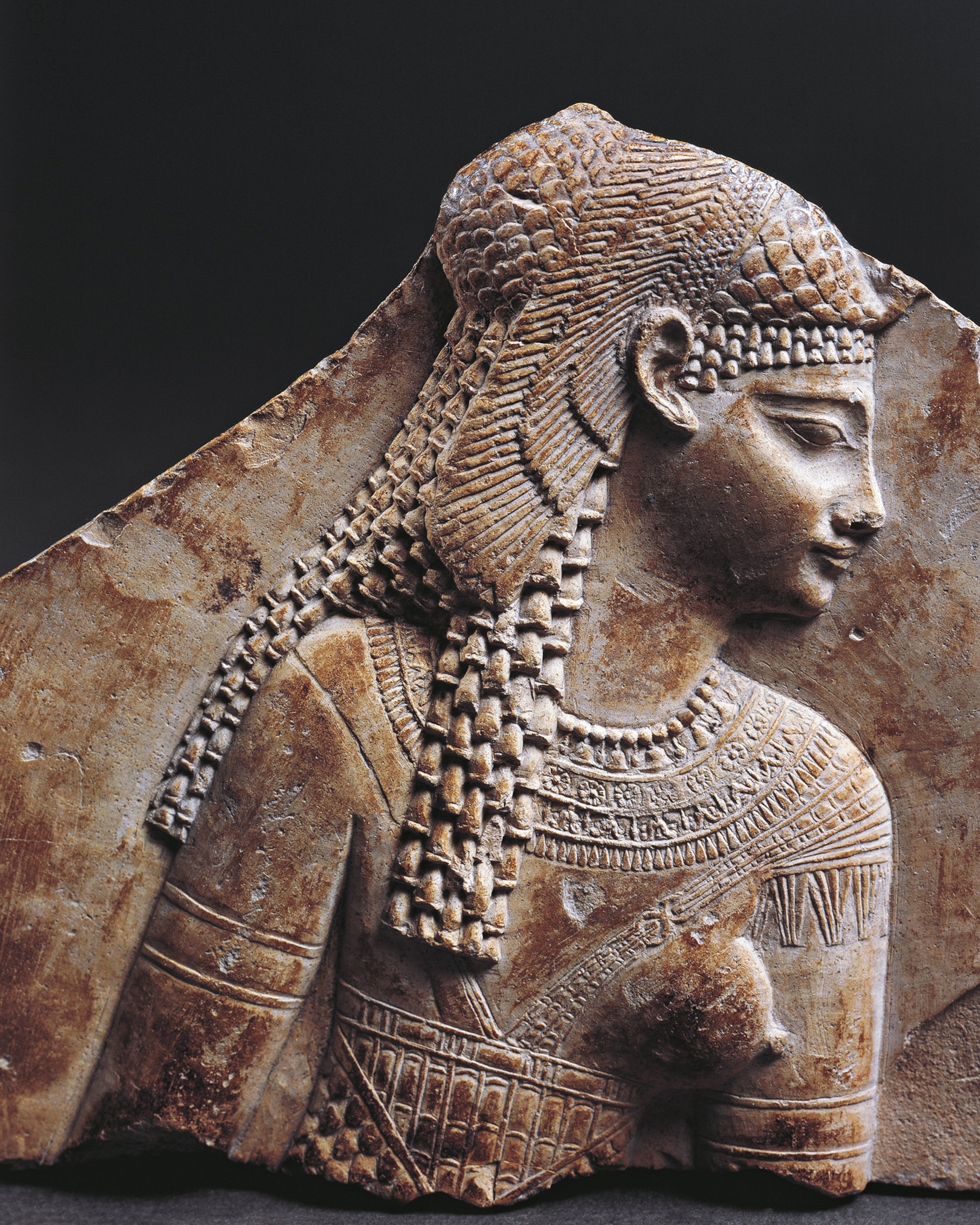 Decaying relieve image of cleopatra carved in a slab of stone.
