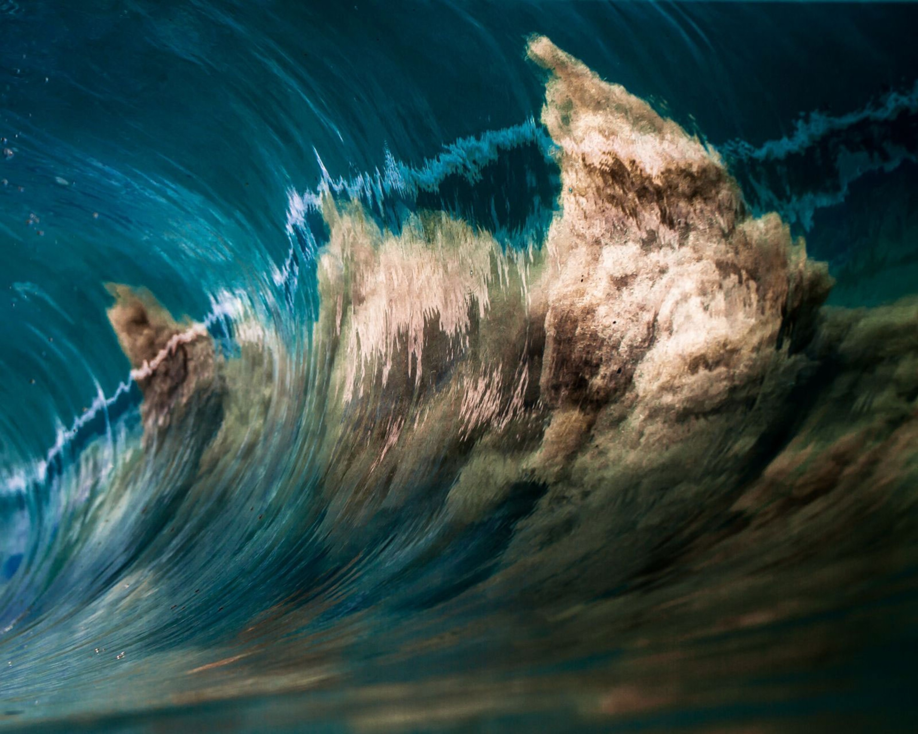 a wave kicking up sand in Hawaii