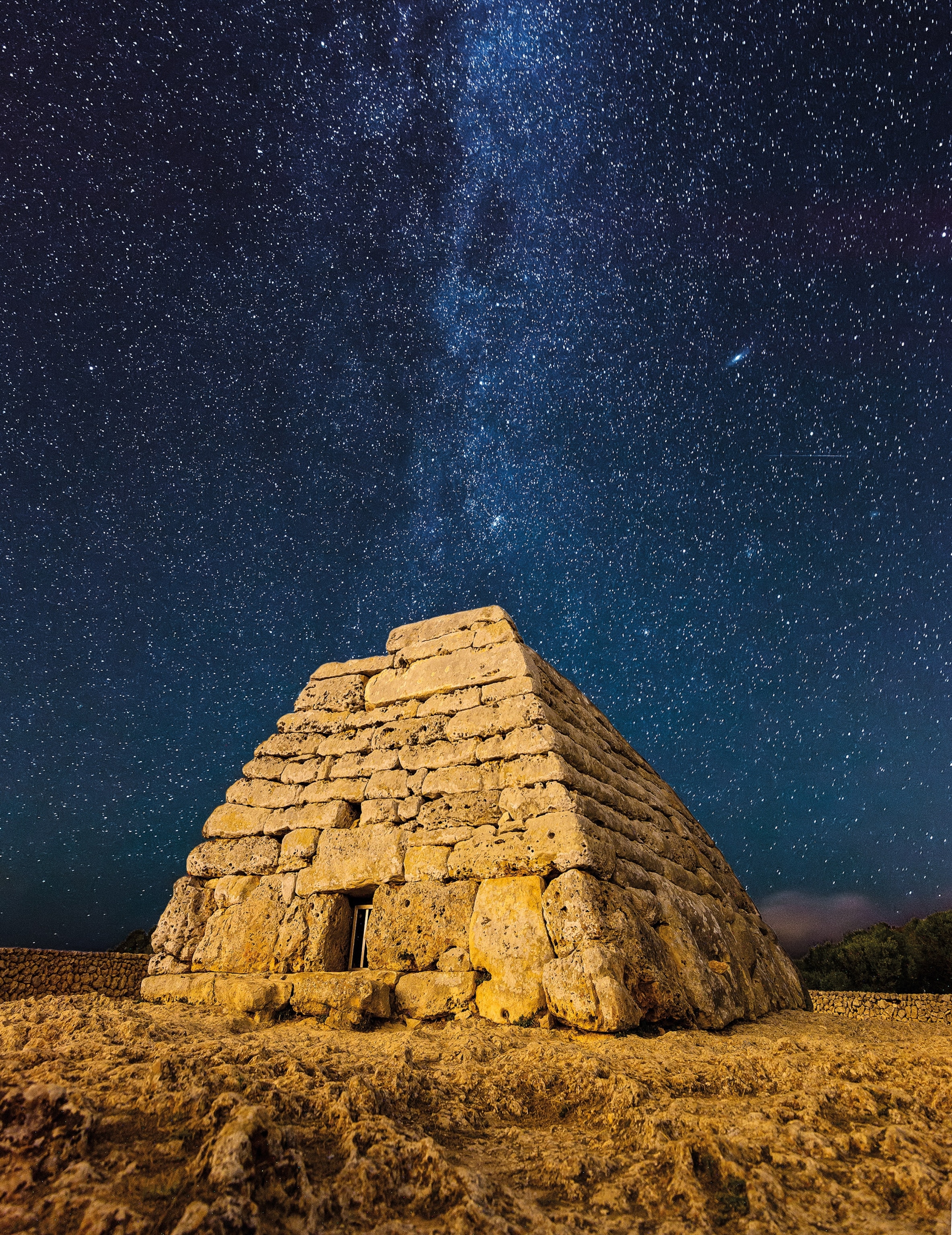 the archeological site of Naveta des Taudons lit up by a sky of stars