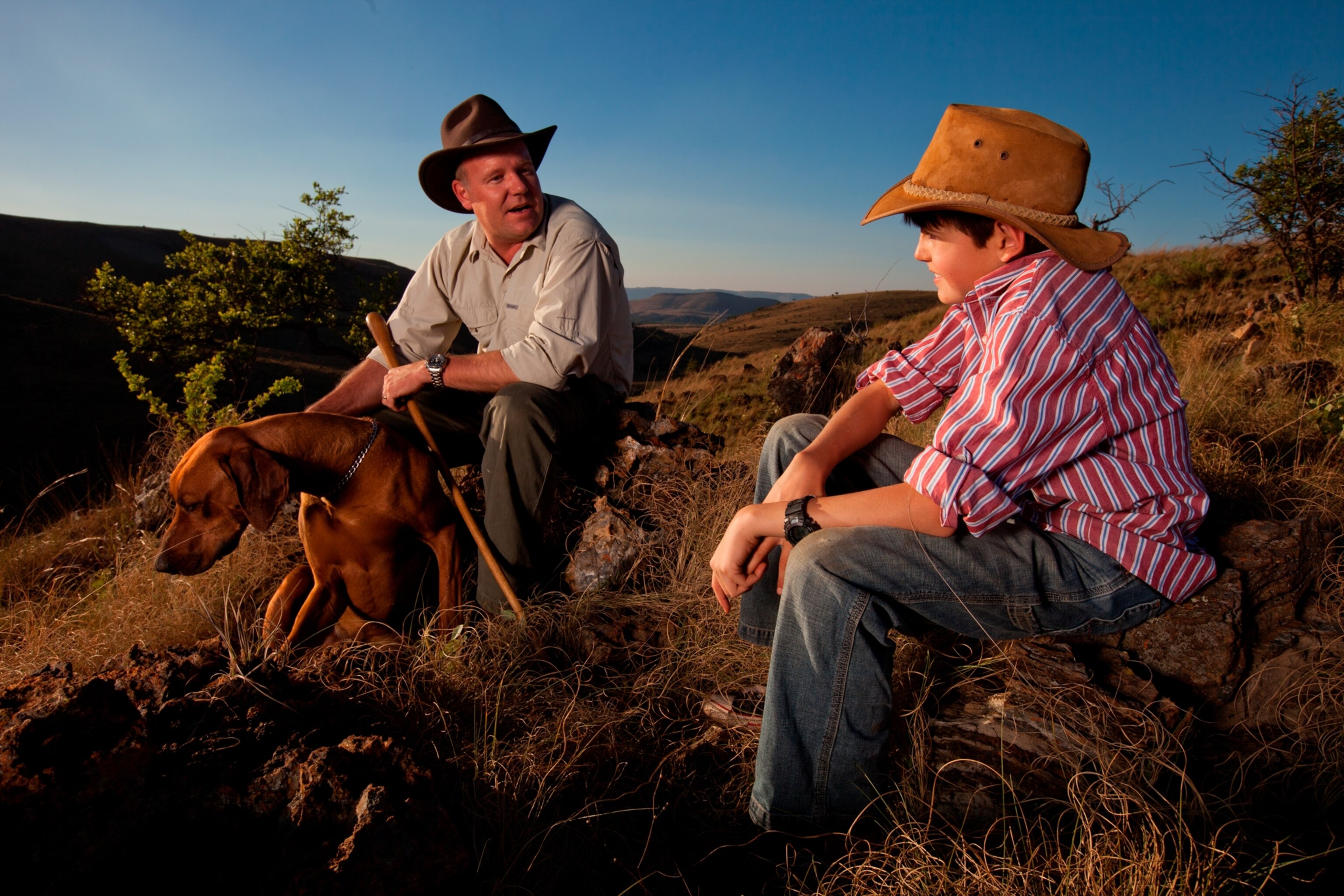 Professor Lee Berger sits with his son and dog.