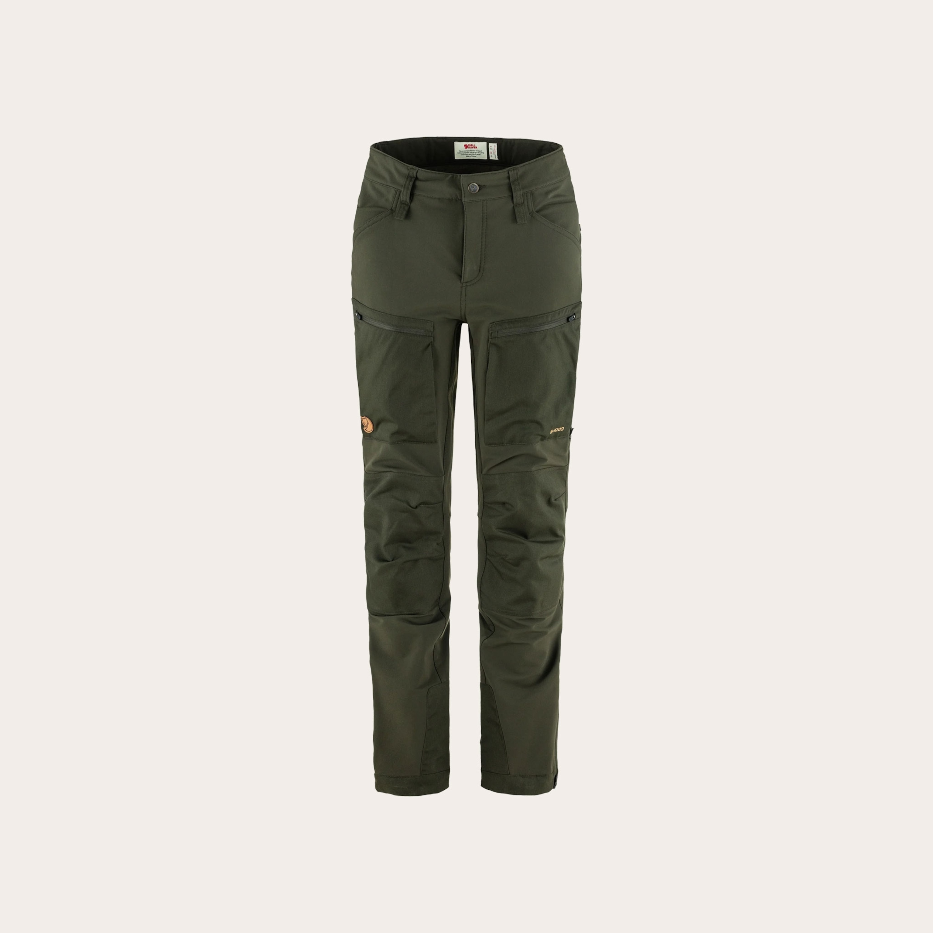 Dark green outdoors pants placed on a tan background.