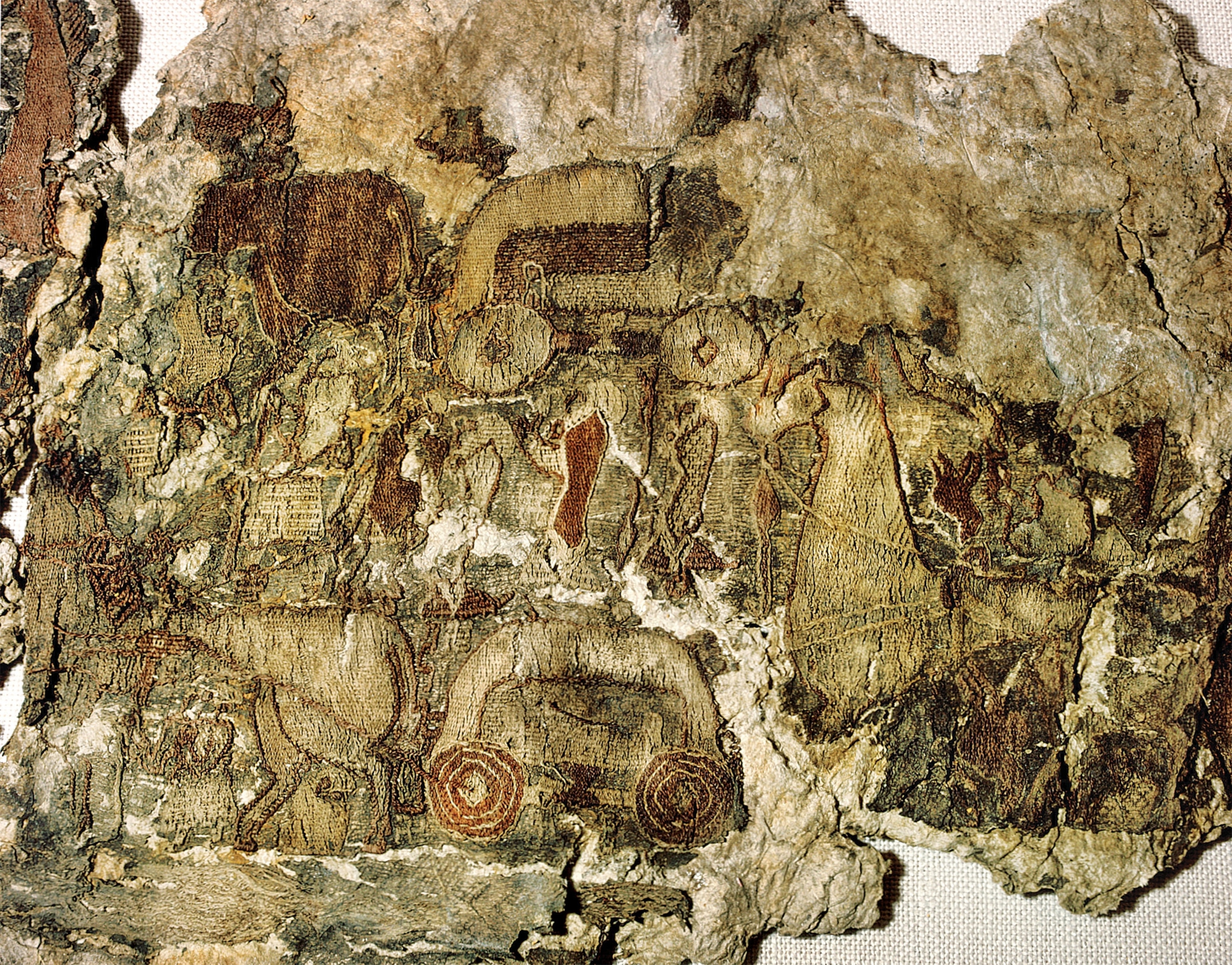 Faded and tattered with time, this rare tapestry was found in the burial ship of the Oseberg women. It may depict a procession of horse-drawn carts and people.
