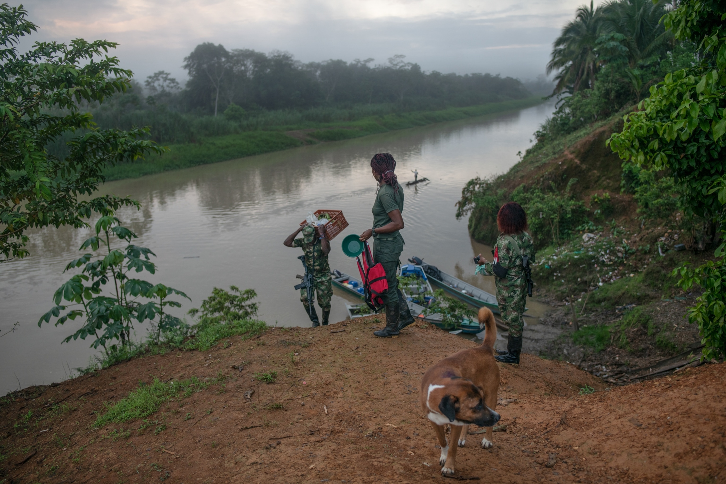 three women carrying their belongings along the San Juan River