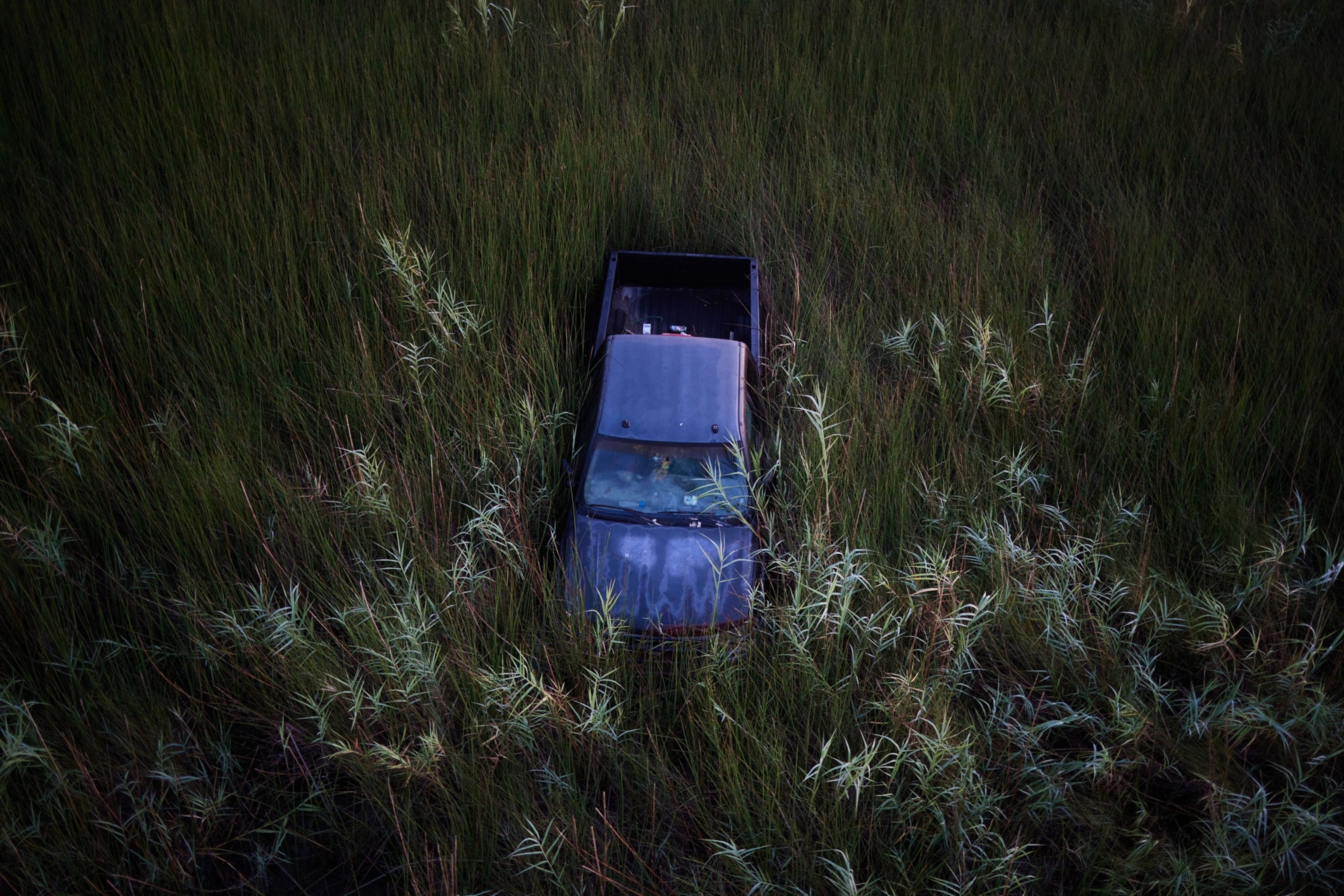 A pickup truck in a march a quarter mile from the closest road after a hurricane hit Louisiana's coast