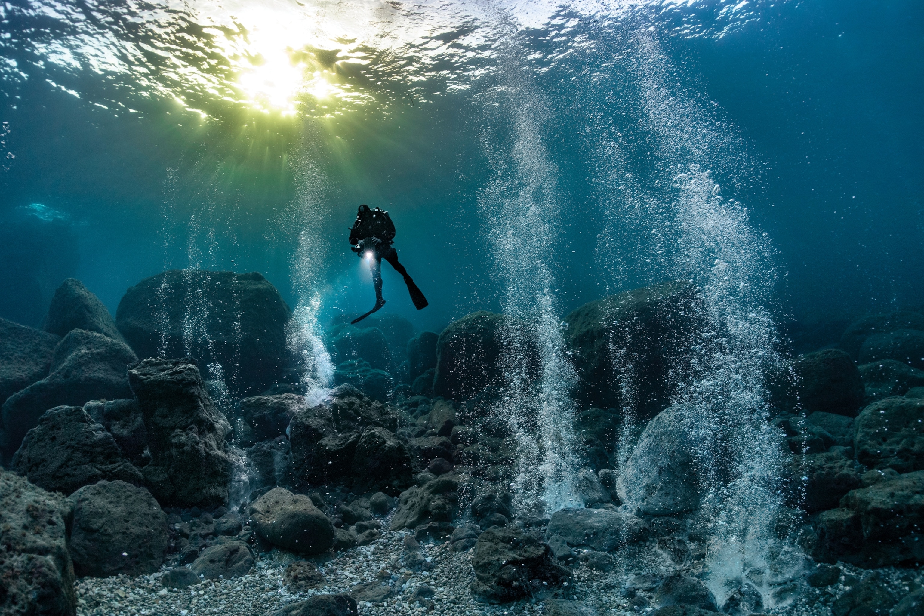 A diver in between babbles geysers.