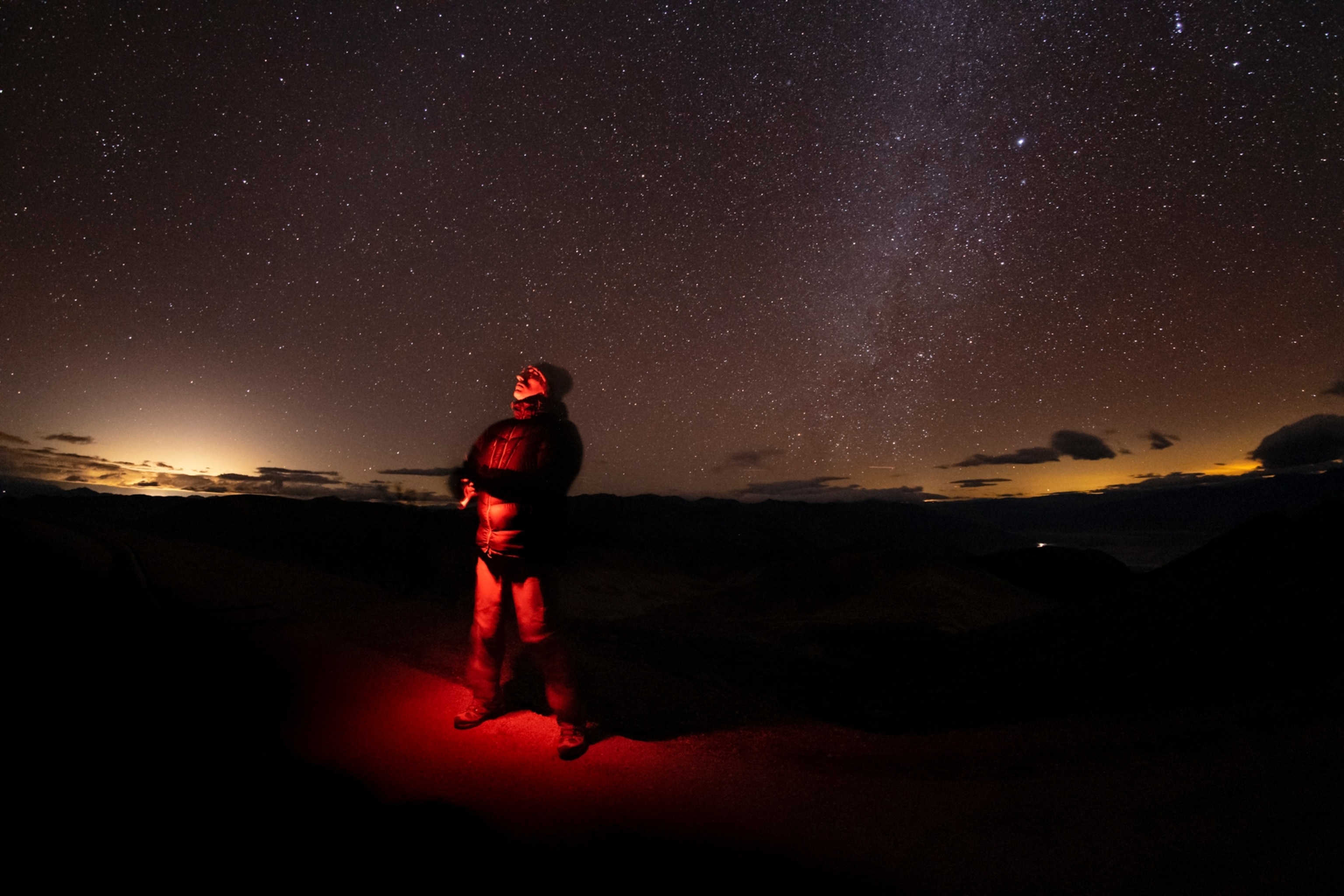 a man standing in the desert at night