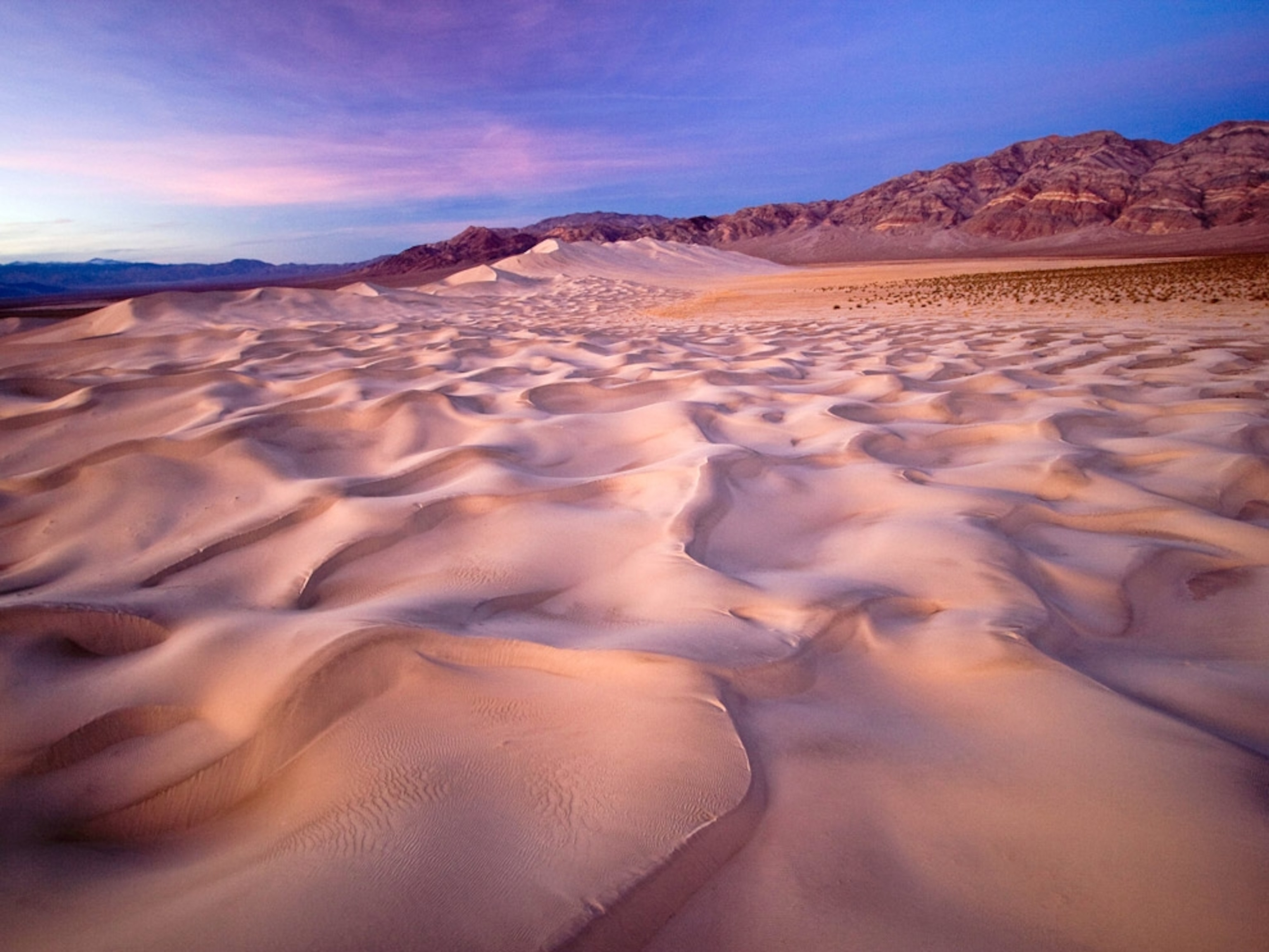 Sand dunes under blue sky