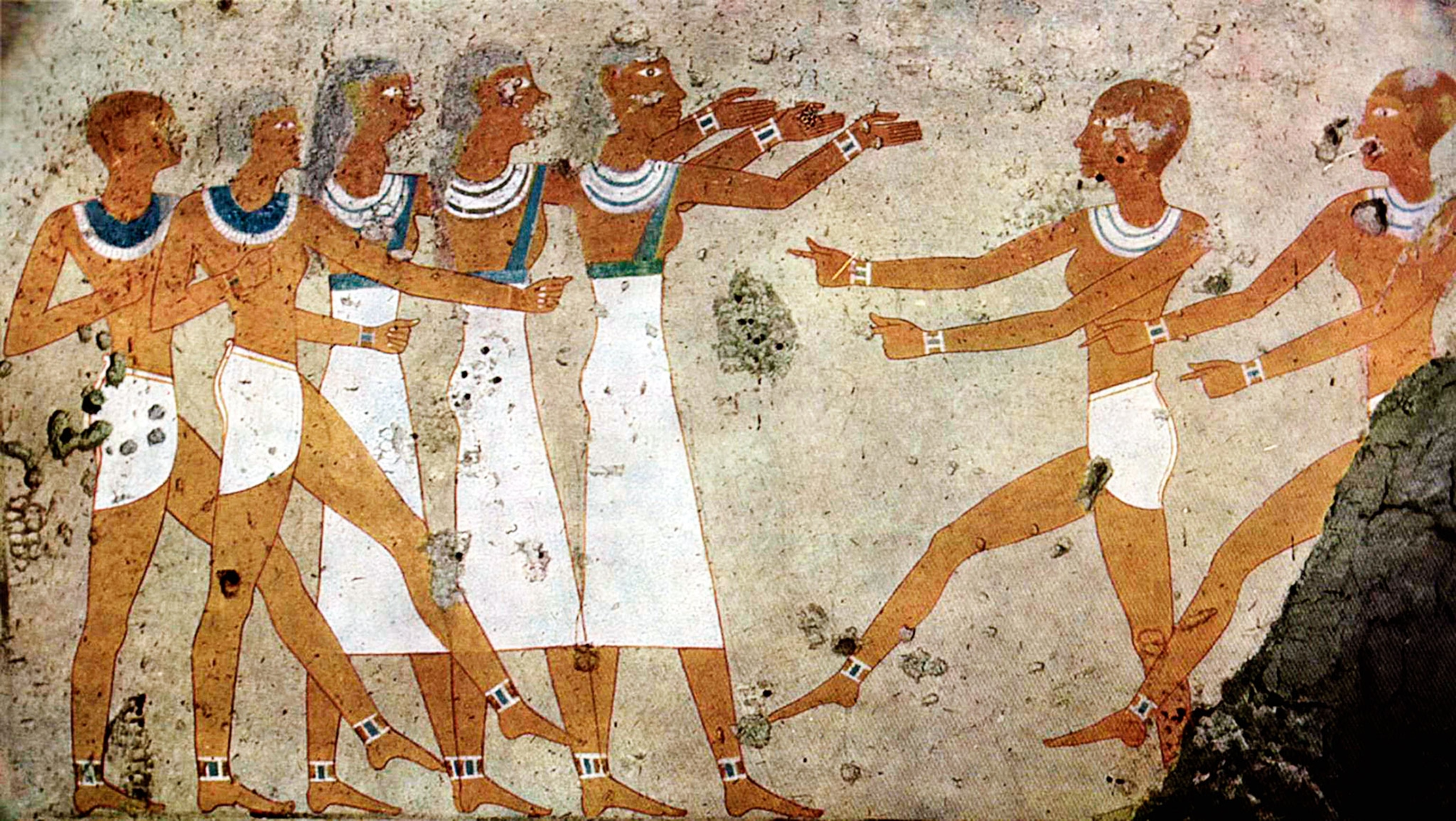 In a painting, people stand in a line dancing, wearing white garb and broad collars