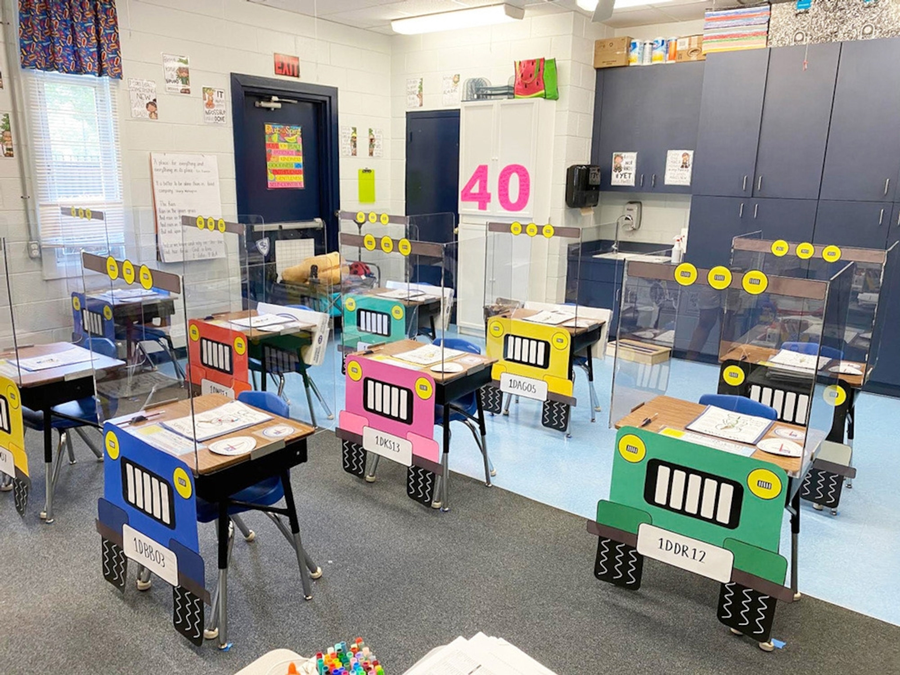 A classroom with plexiglass barriers at each desk, which have been decorated to resemble Jeeps. St. Barnabas Episcopal School, DeLand, Florida.