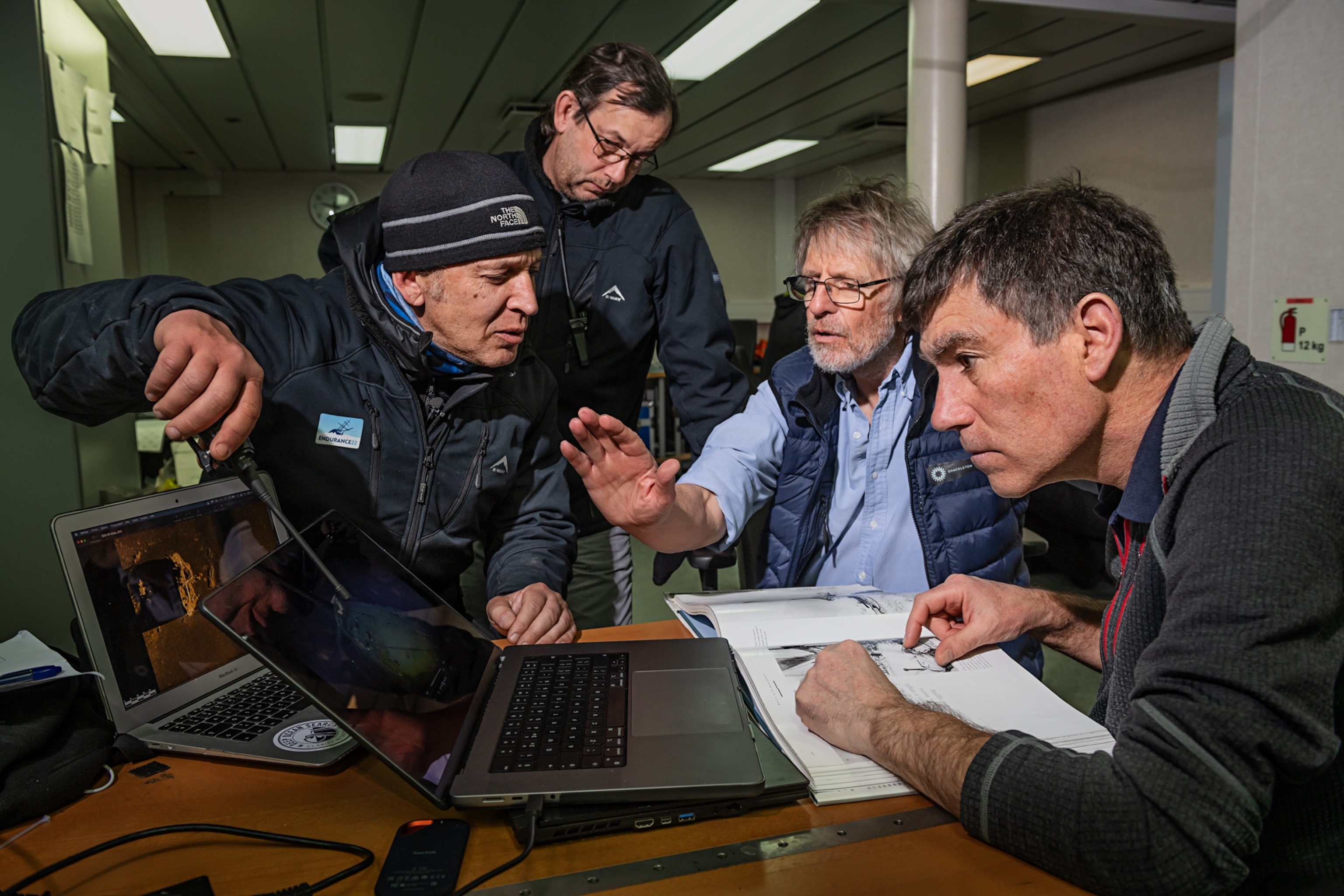 Four people look at the first videos and laser images of Endurance.
