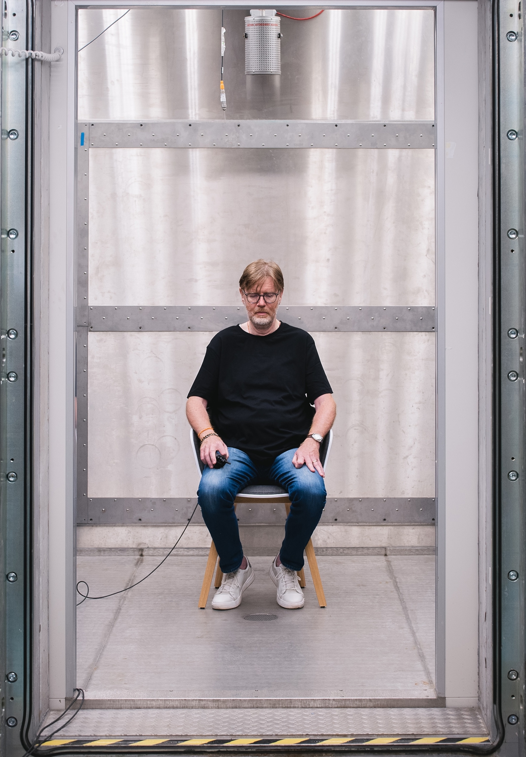 Gunther Cologna sits as a participant for an experiment about thermal perception in one of the rooms of the research center in Bolzano, Italy.