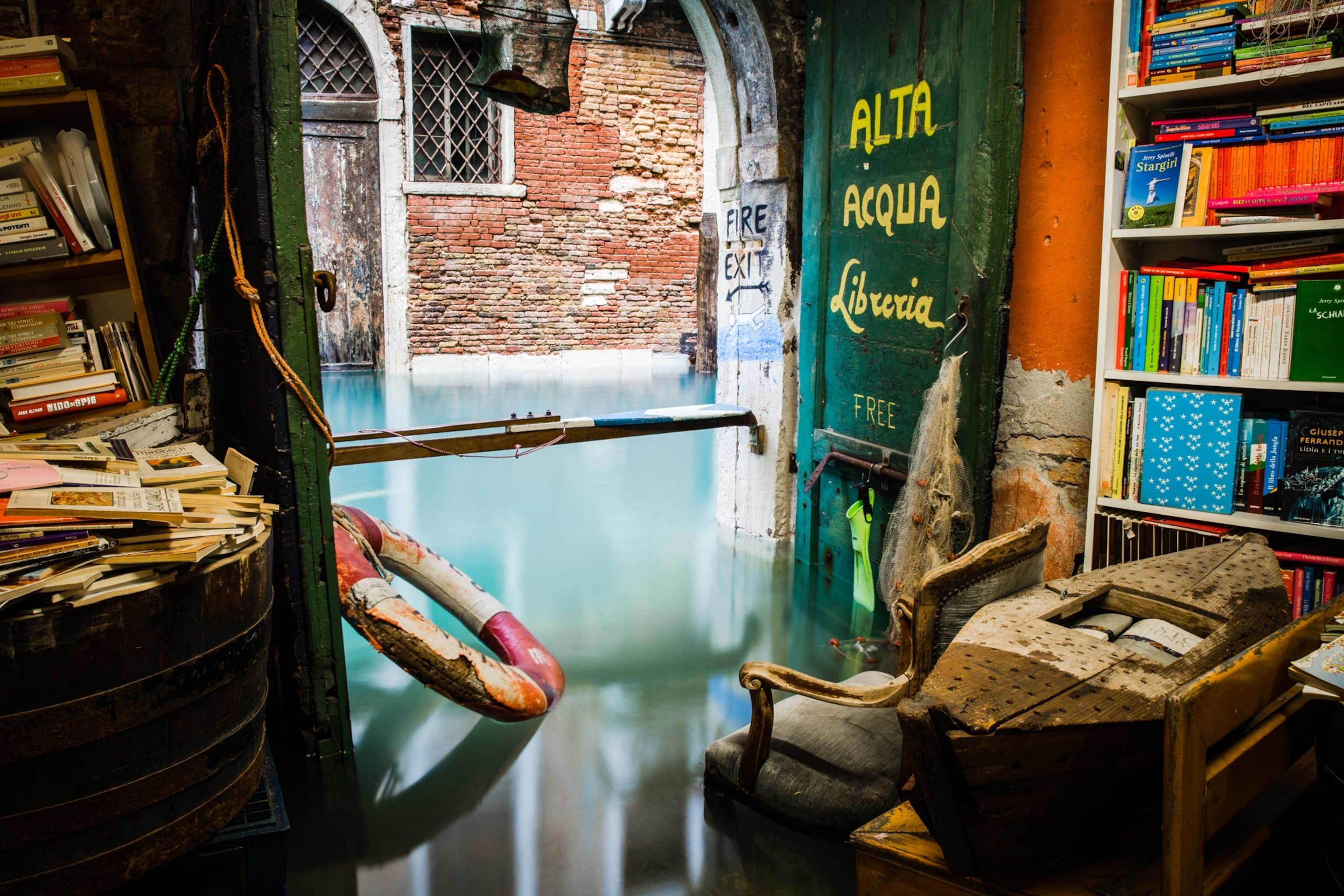 High water from a Venetian canal which has flooded the floor of a bookstore.