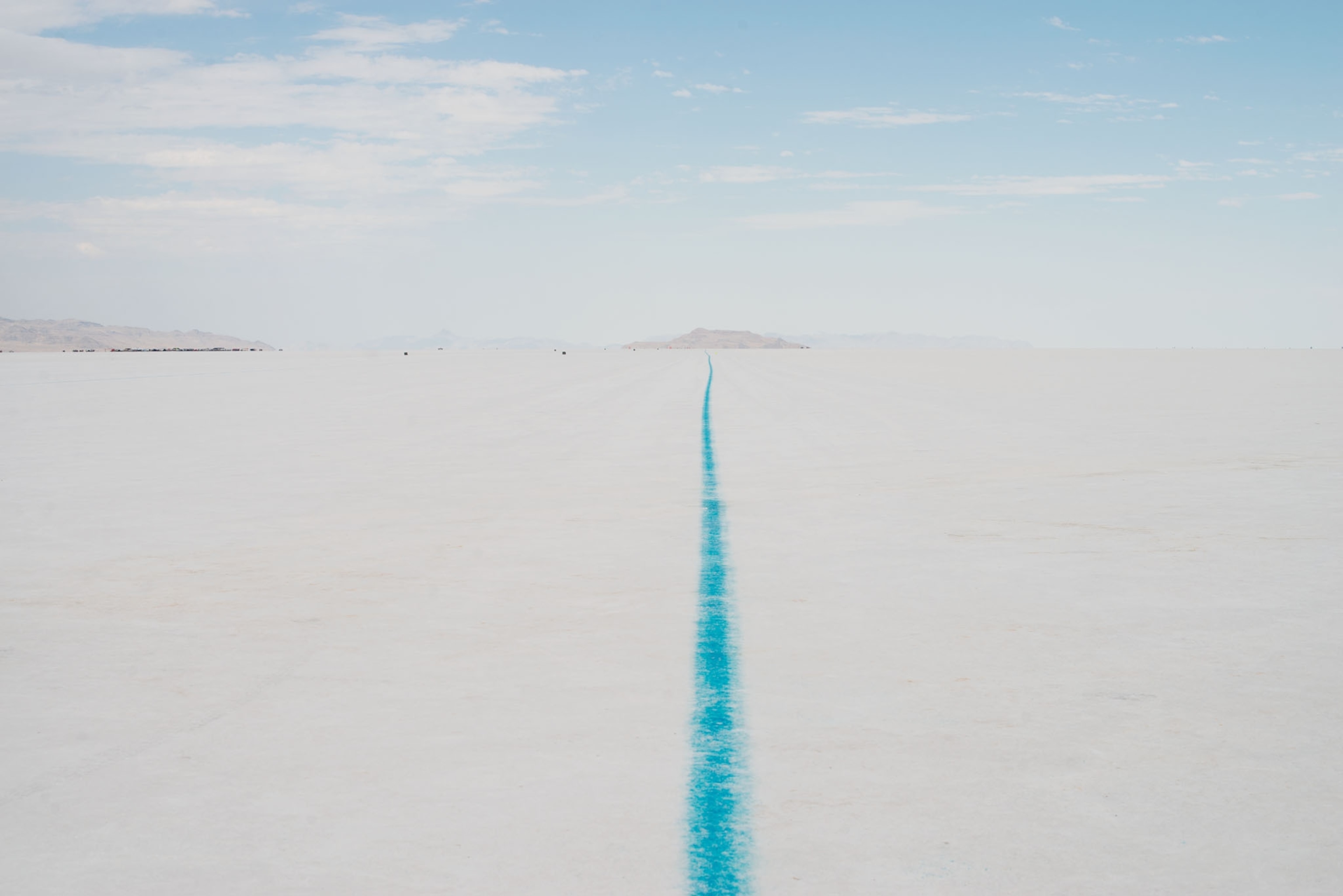 a white and crystal blue landscape of salt flats