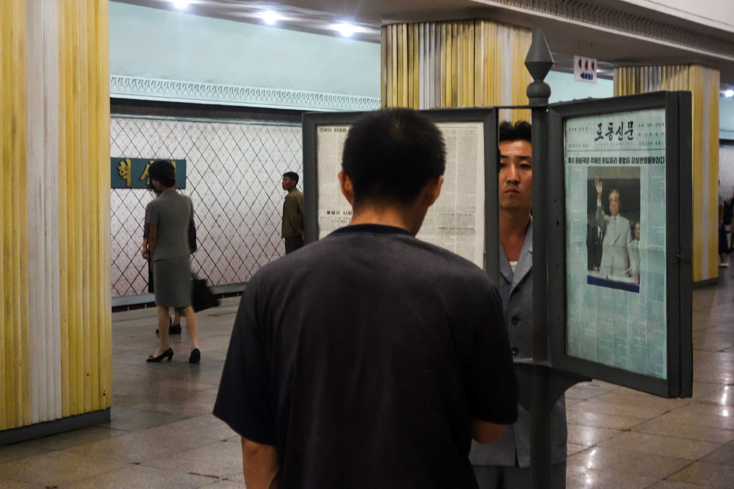 North Koreans reading the newspaper