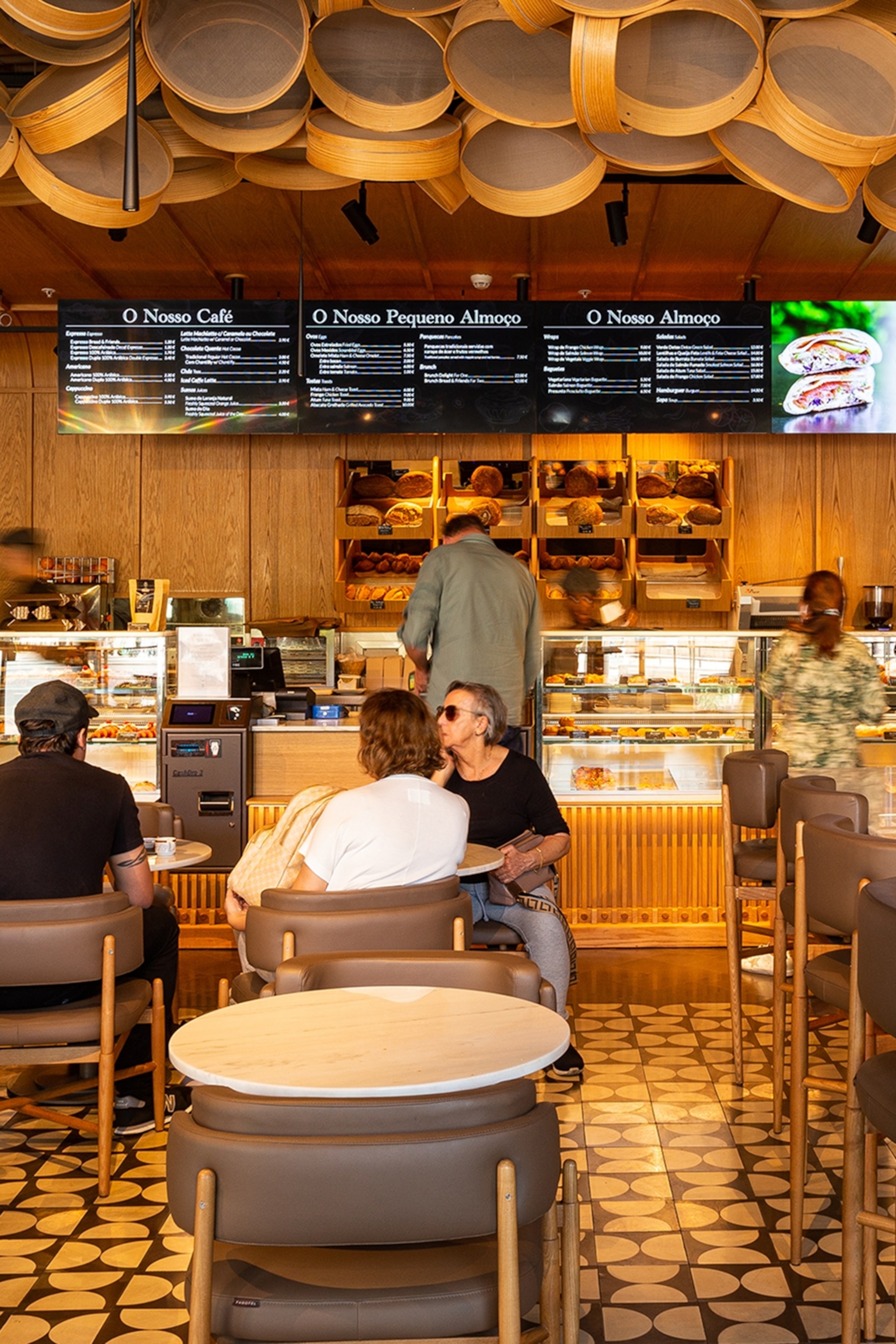 Interior of a cafe with people sat at tables