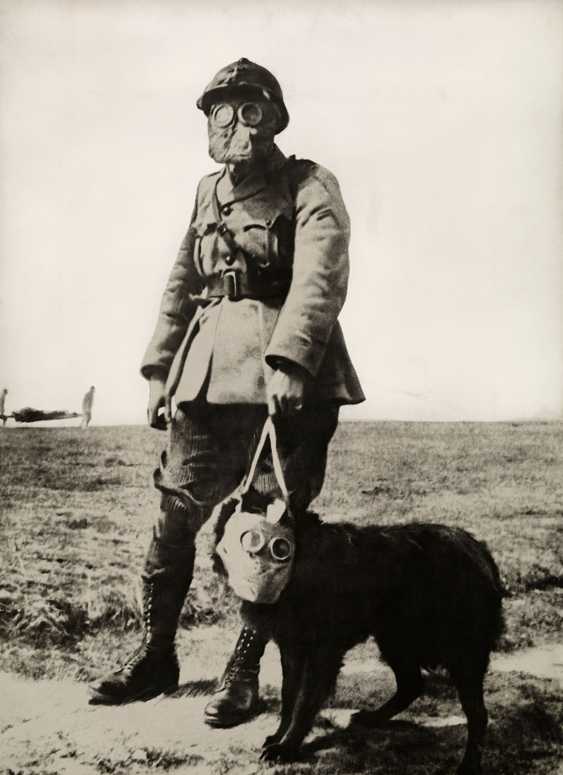 a man and a dog with gas masks on