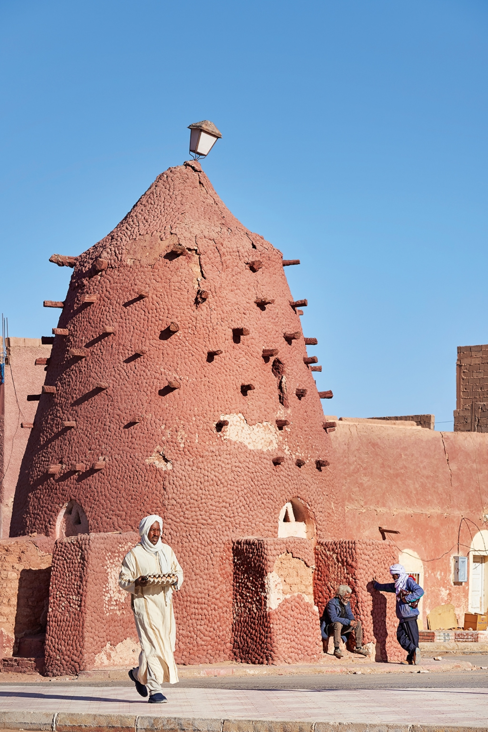A ksour in Algeria, a type of dome shaped building which tapers into a point, and is a rich, browny red colour.