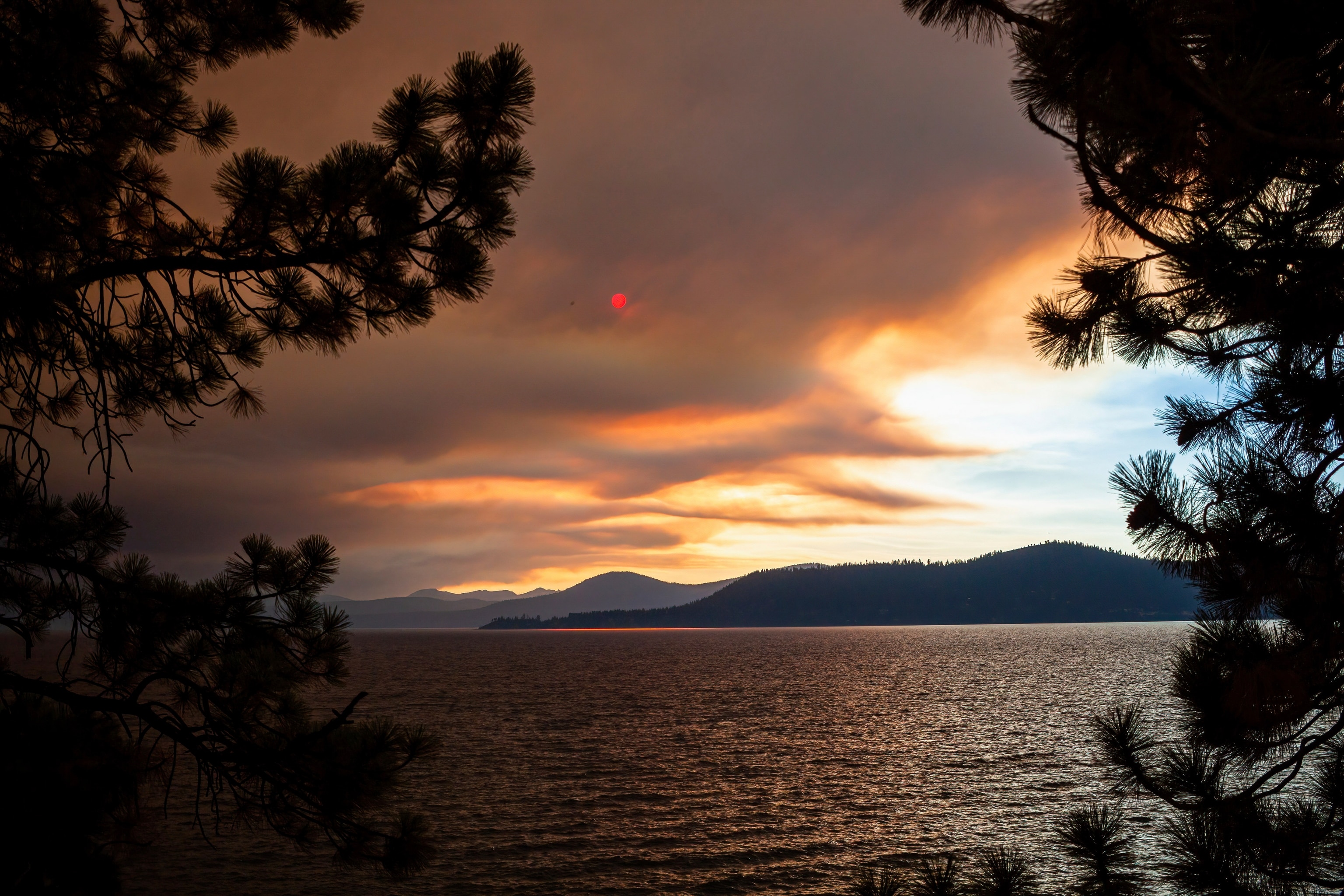 Wildfire smoke clouds over Lake Tahoe at sunset. Clouds of smoke from the Mosquito fire cover Lake Tahoe at sunset.