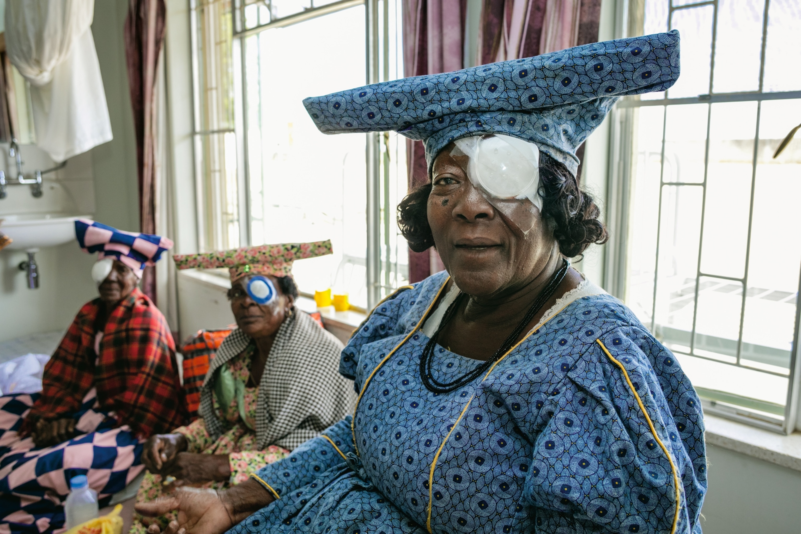 Herero women in Namibia awaiting removal of their bandages after cataract surgery