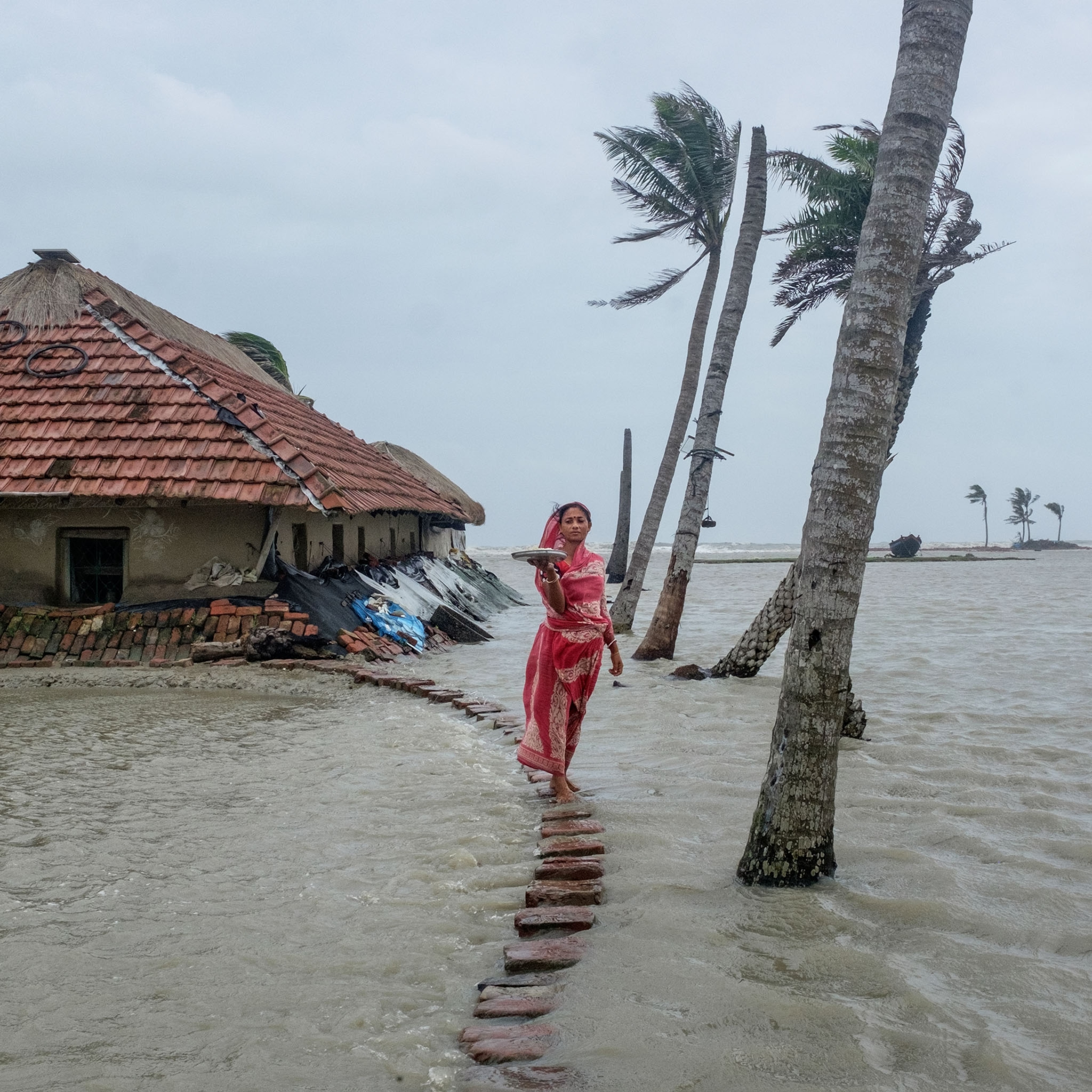 a woman standing for a portrait in a flooded area