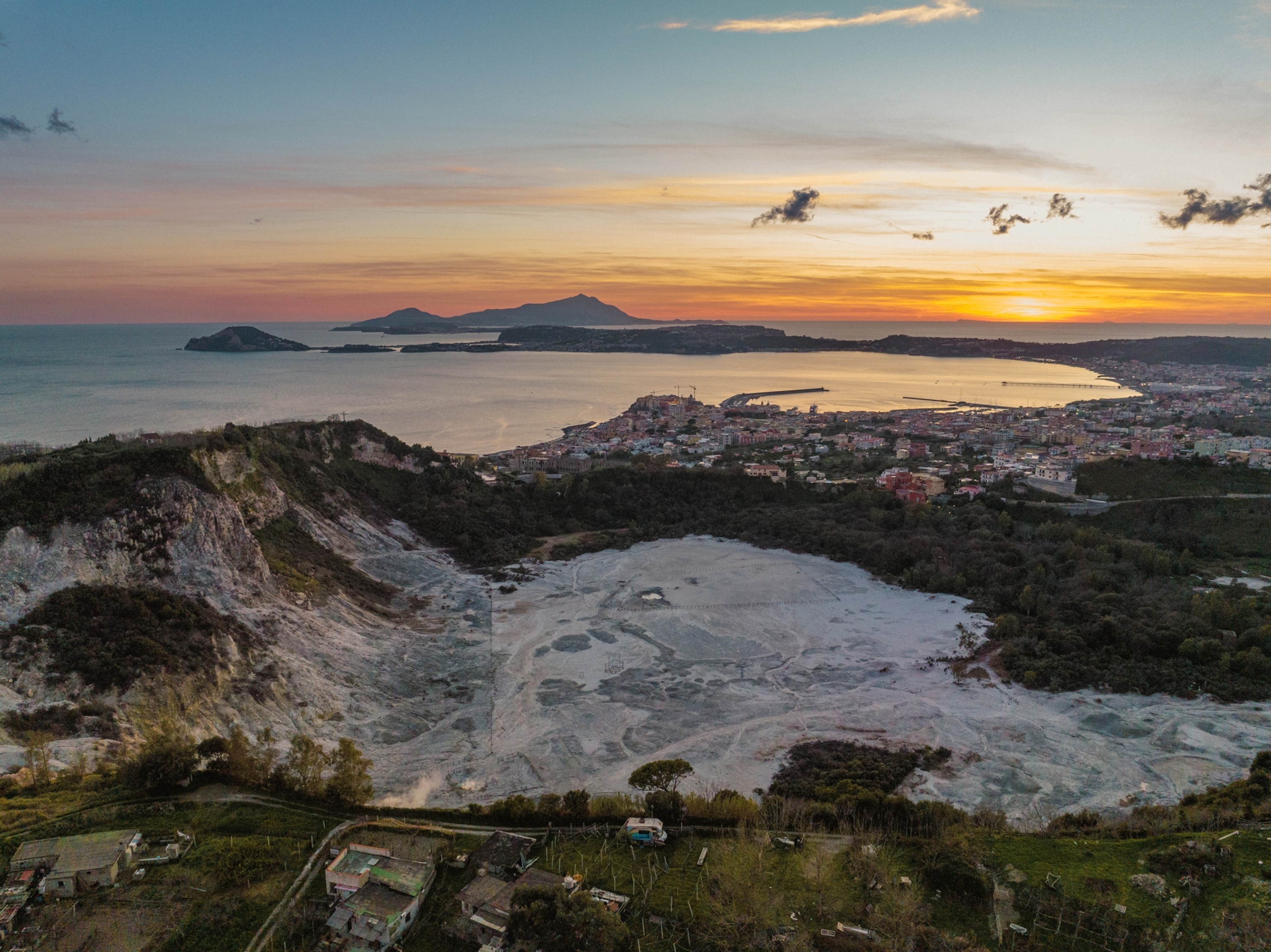 An aerial view of Solfatara with the town of Pozzuoli in the background.