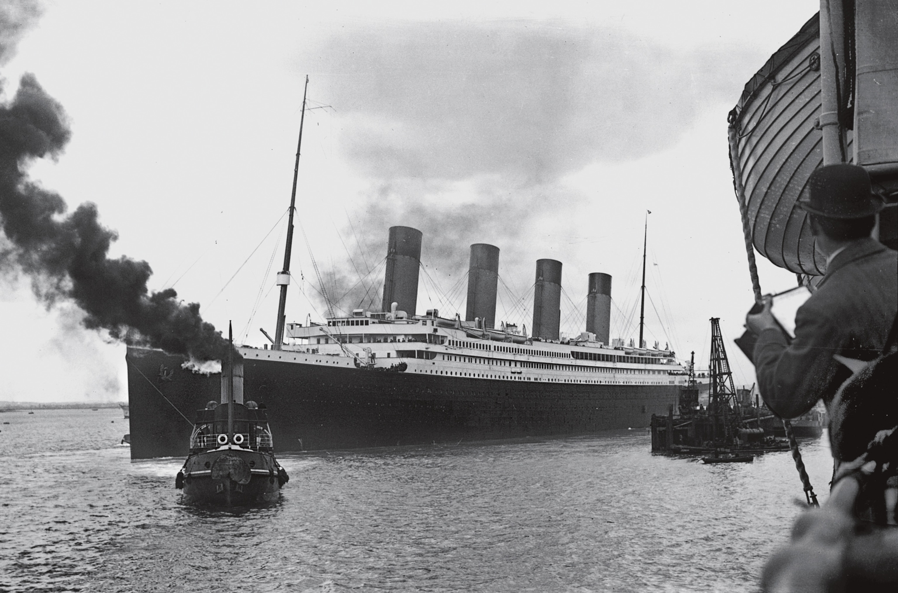 a tugboat guiding Titanic out of Southampton