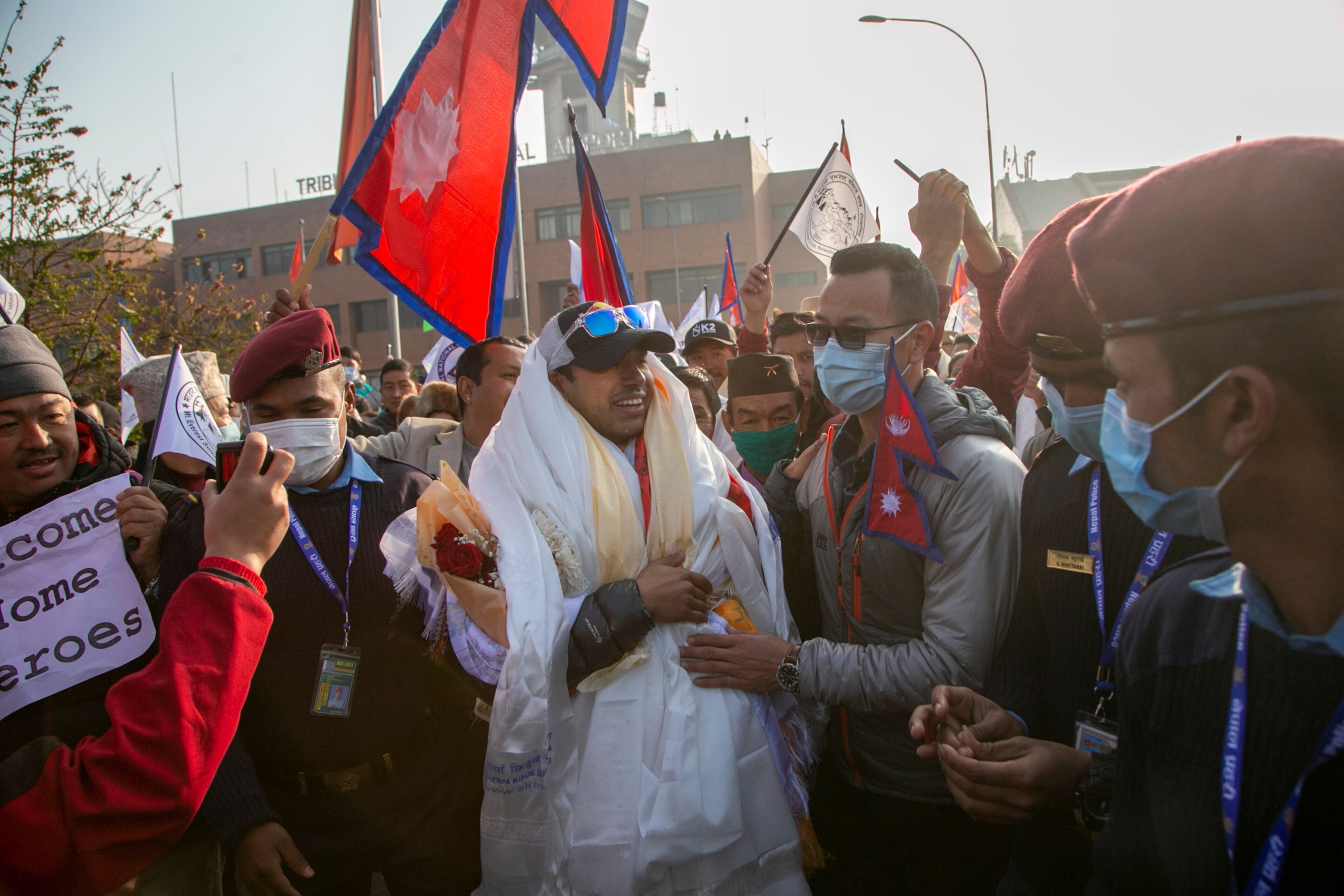 Nirmal Purja one of the team member of the all-Nepalese mountaineering team receives a scarf as they arrive at Tribhuwan International airport