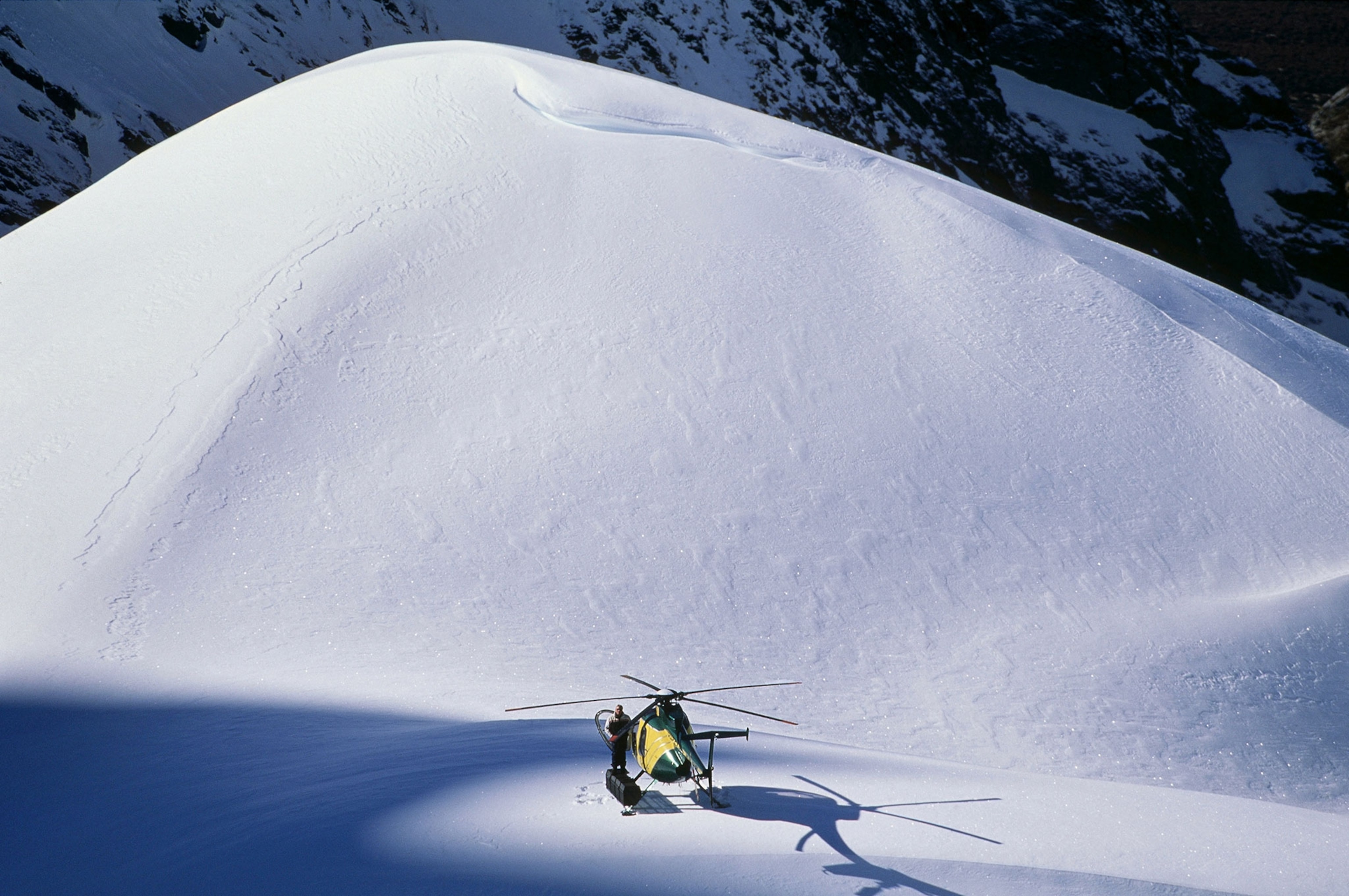 a helicopter pilot waiting for heli-skiers to return New Zealand
