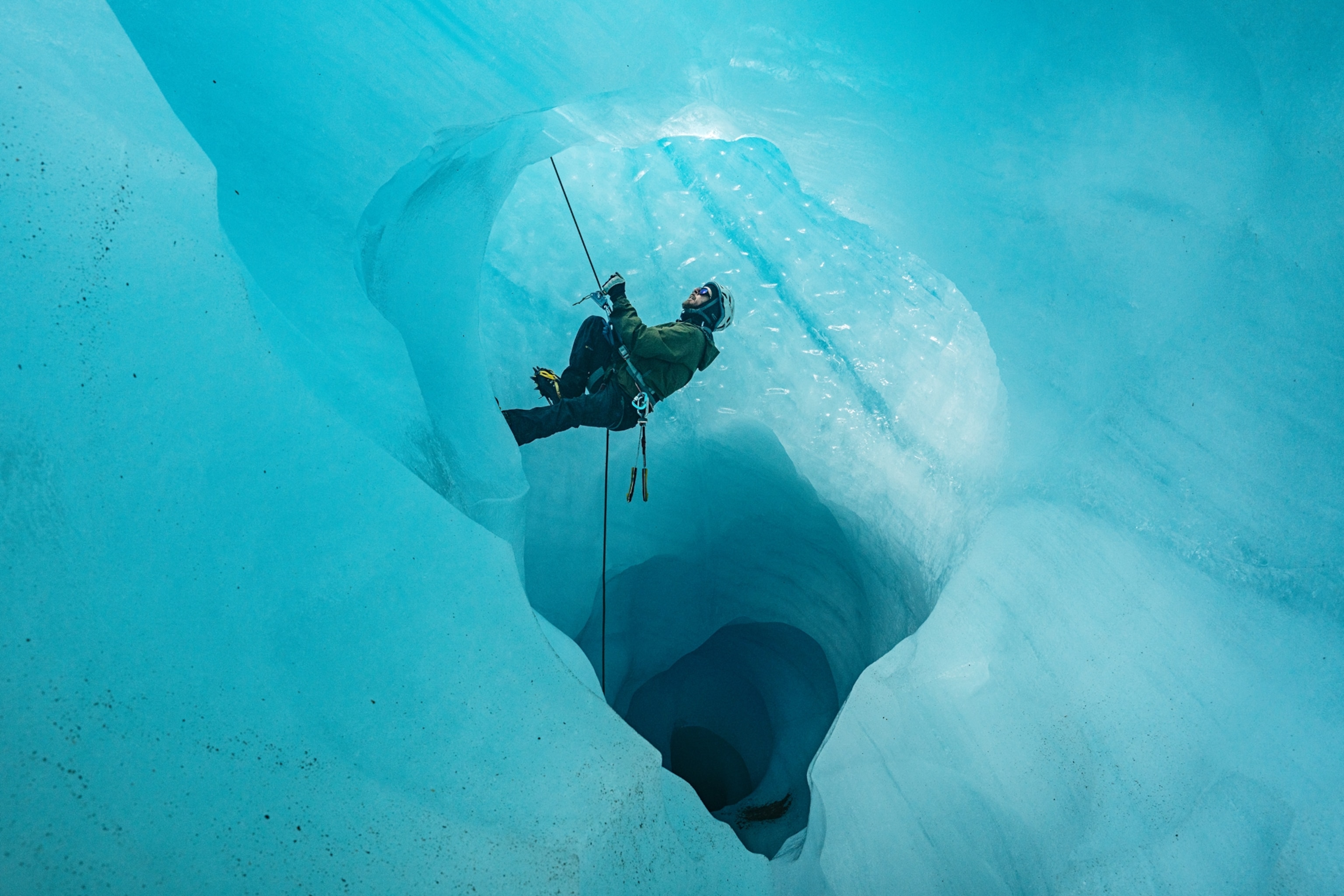 A military mountaineering instructor, climbs an ice cave on the Explorers Glacier.